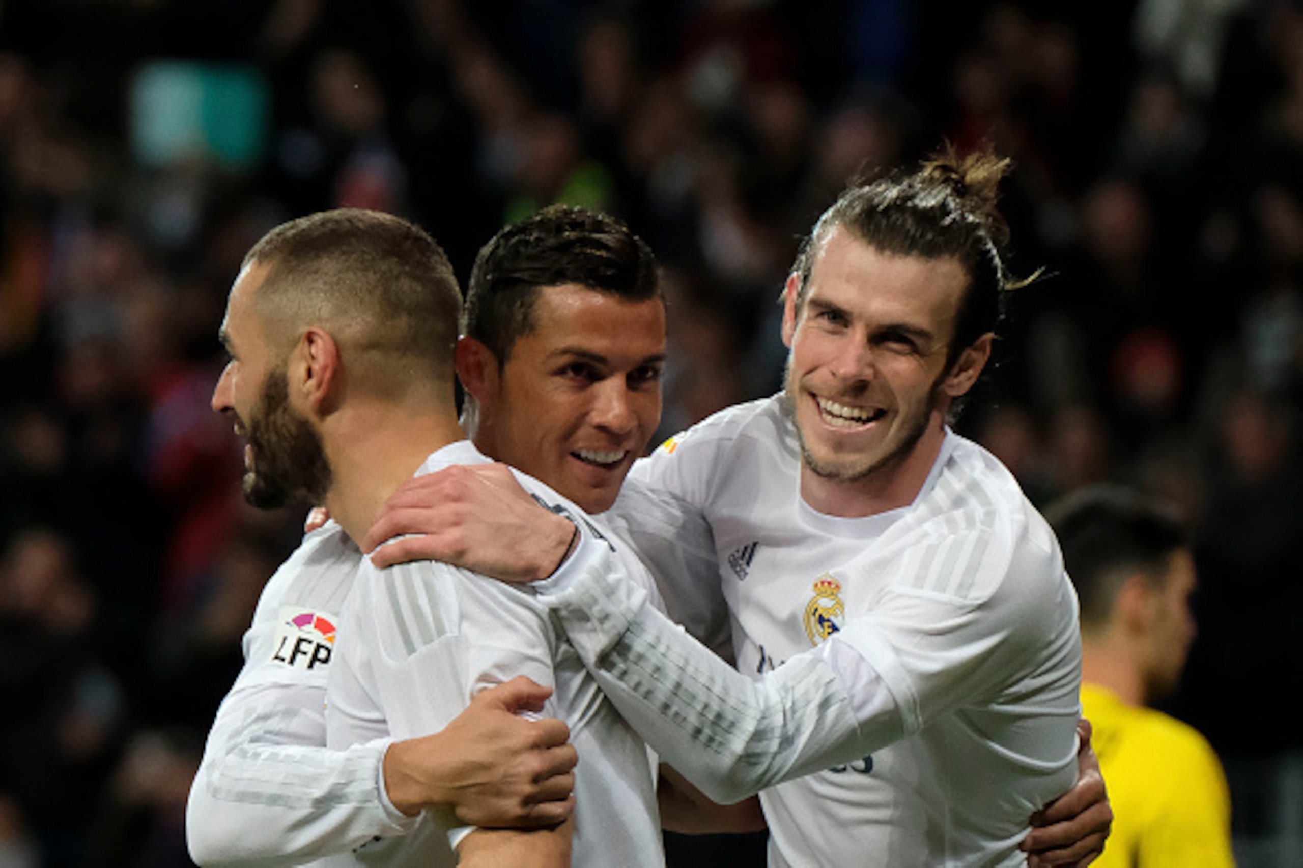 Real Madrid's Welsh forward Gareth Bale (R), Real Madrid's French forward Karim Benzema (L) and Real Madrid's Portuguese forward Cristiano Ronaldo (C) celebrate scoring during the Spanish league football match Real Madrid CF vs Sevilla FC at the Santiago 