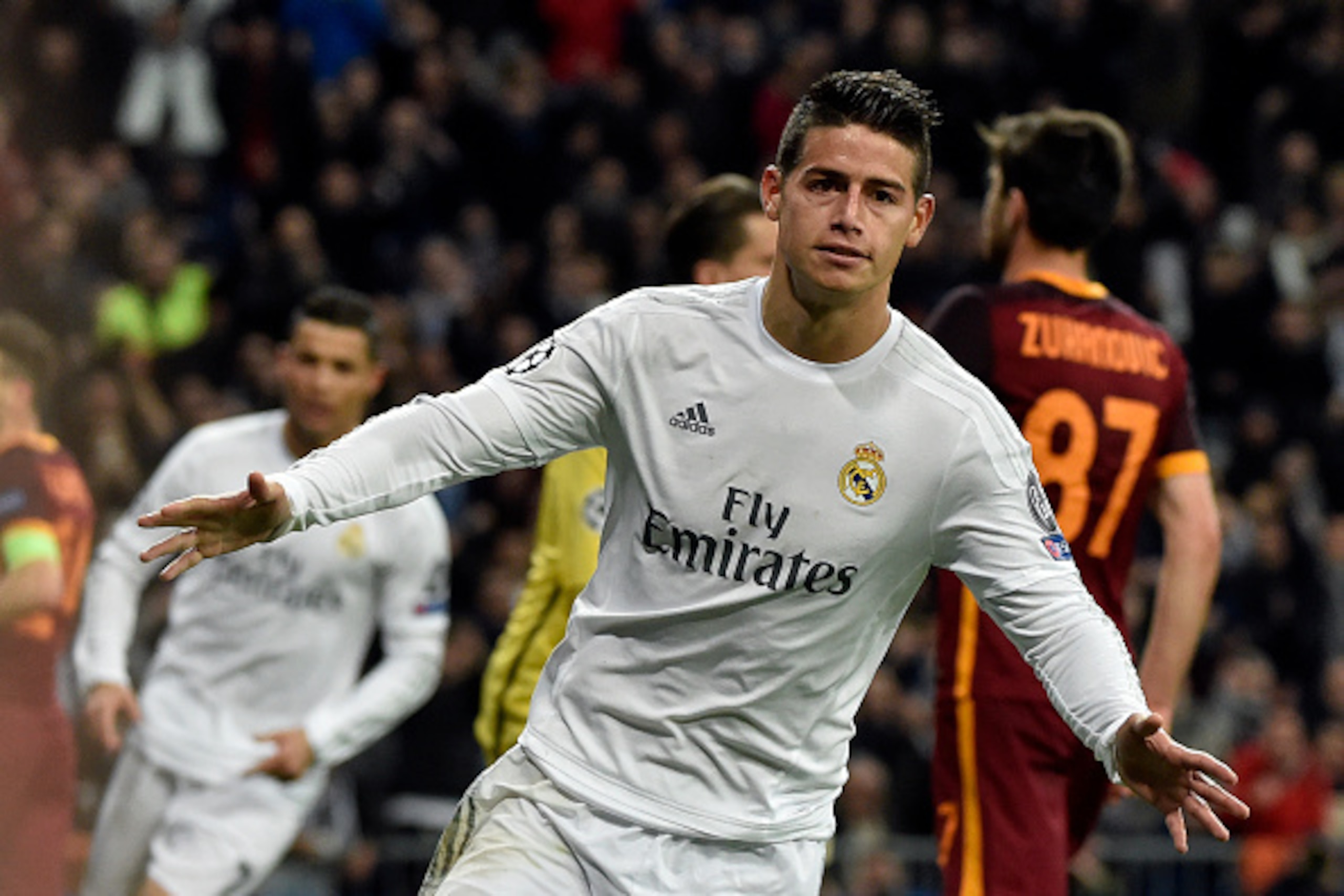 TOPSHOT - Real Madrid's Colombian midfielder James Rodriguez celebrates after scoring  during the UEFA Champions League round of 16, second leg football match Real Madrid FC vs AS Roma at the Santiago Bernabeu stadium in Madrid on March 8, 2016. / AFP / G