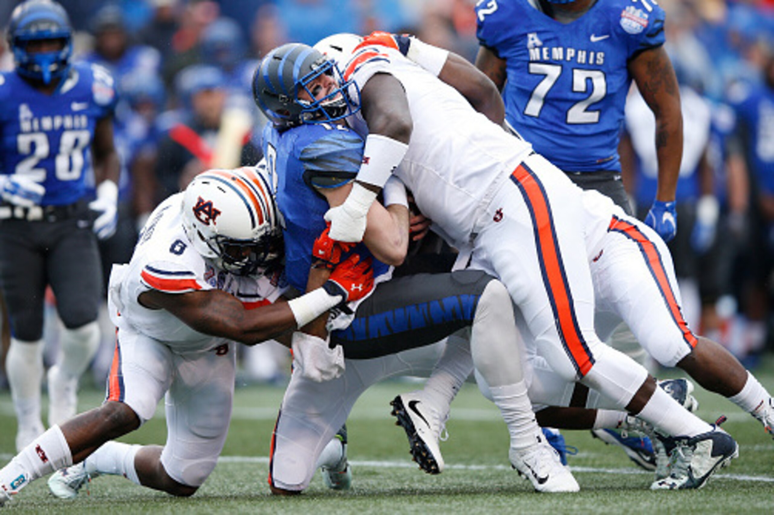 BIRMINGHAM, AL - DECEMBER 30: Paxton Lynch #12 of the Memphis Tigers is sacked by Montravius Adams #1 and Cassanova McKinzy #8 of the Auburn Tigers during the Birmingham Bowl at Legion Field on December 30, 2015 in Birmingham, Alabama. Auburn defeated Mem