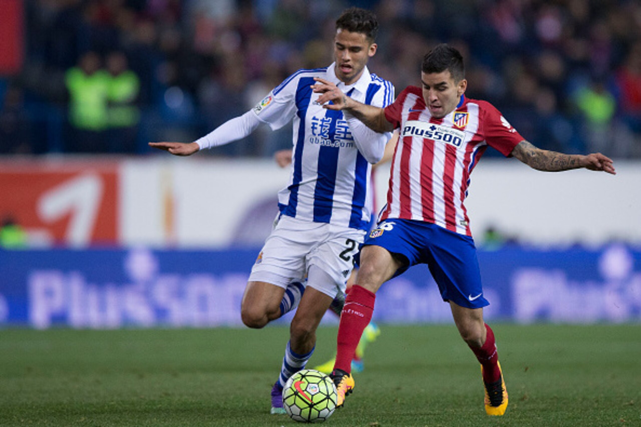 MADRID, SPAIN - MARCH 01: Angel Martin Correa (R) of Atletico de Madrid competes for the ball with Diego Reyes (L) of Real Sociedad de Futbol during the La Liga match between Club Atletico de Madrid and Real Sociedad de Futbol at Vicente Calderon Stadium 