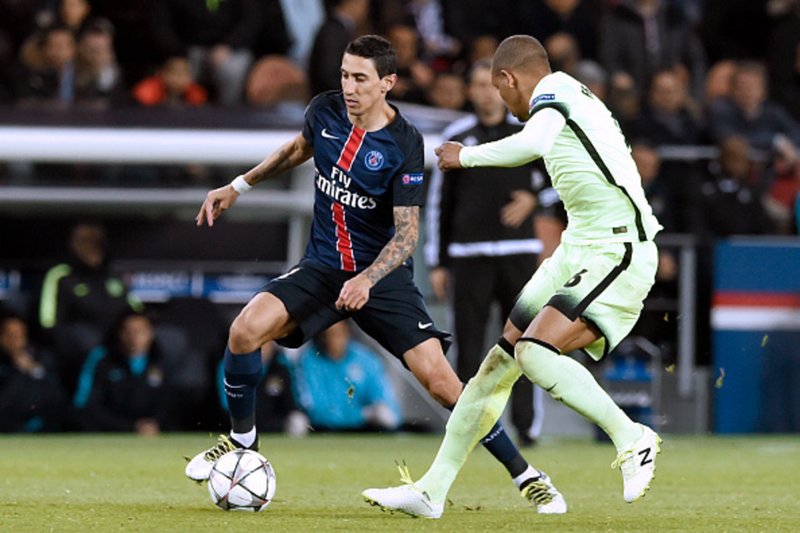 Paris Saint-Germain's Argentinian forward Angel Di Maria (L) vies with Manchester City's Brazilian midfielder Fernando during the UEFA Champions League quarter final football match between Paris Saint Germain (PSG) and Manchester City on April 6, 2016 at 