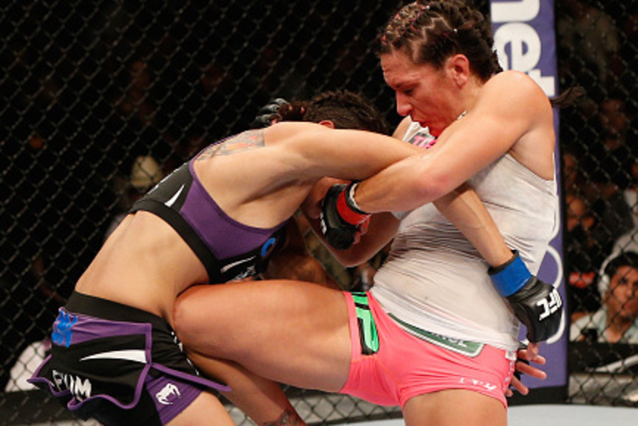 LAS VEGAS, NV - SEPTEMBER 27:  (R-L) Cat Zingano knees Amanzda Nunes in their women's bantamweight fight during the UFC 178 event inside the MGM Grand Garden Arena on September 27, 2014 in Las Vegas, Nevada.  (Photo by Josh Hedges/Zuffa LLC/Zuffa LLC via 