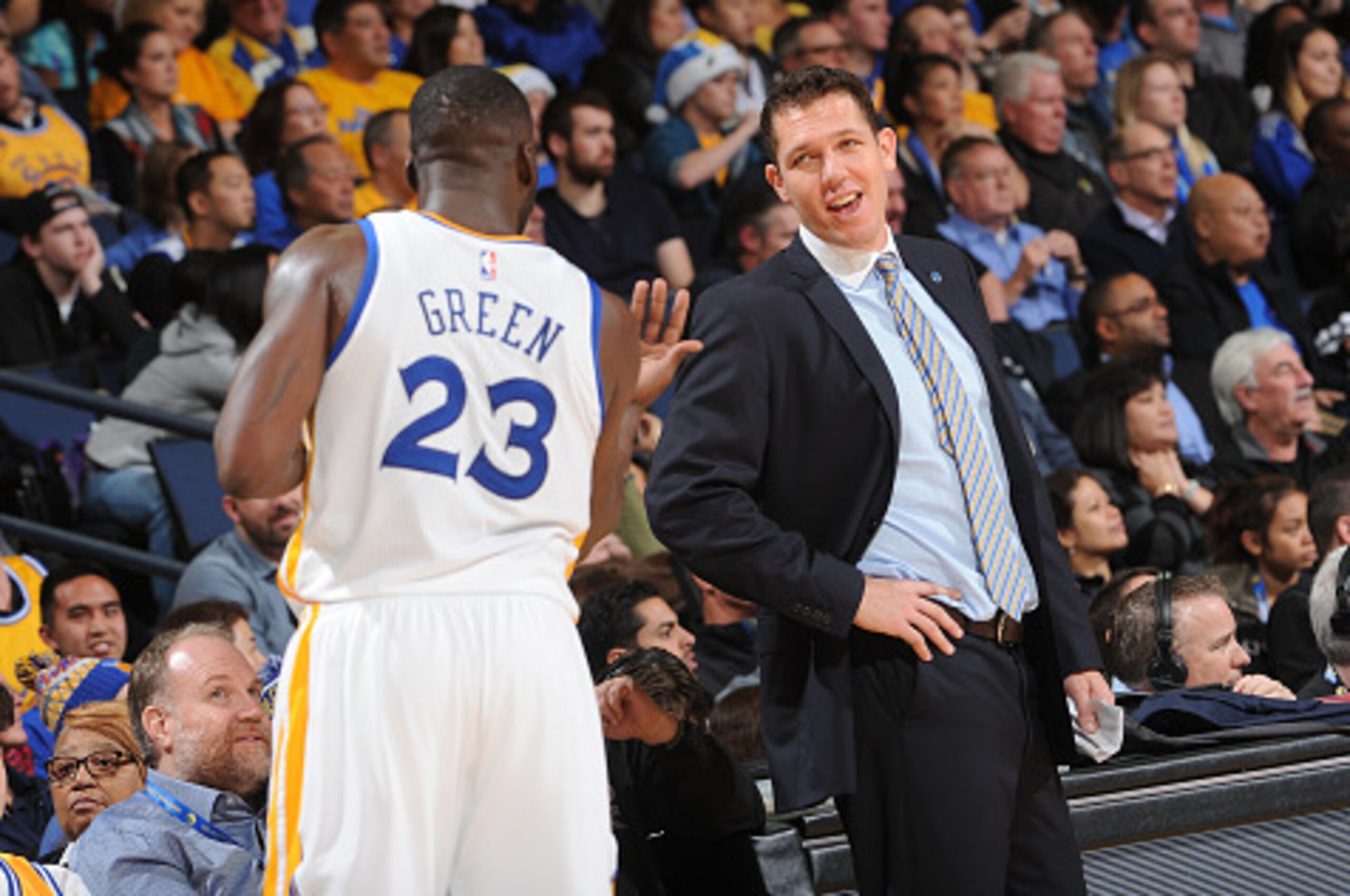 OAKLAND, CA - JANUARY 4: Draymond Green #23 chats with Interim Head coach Luke Walton of the Golden State Warriors while facing the Charlotte Hornets on January 4, 2016 at Oracle Arena in Oakland, California. NOTE TO USER: User expressly acknowledges and 