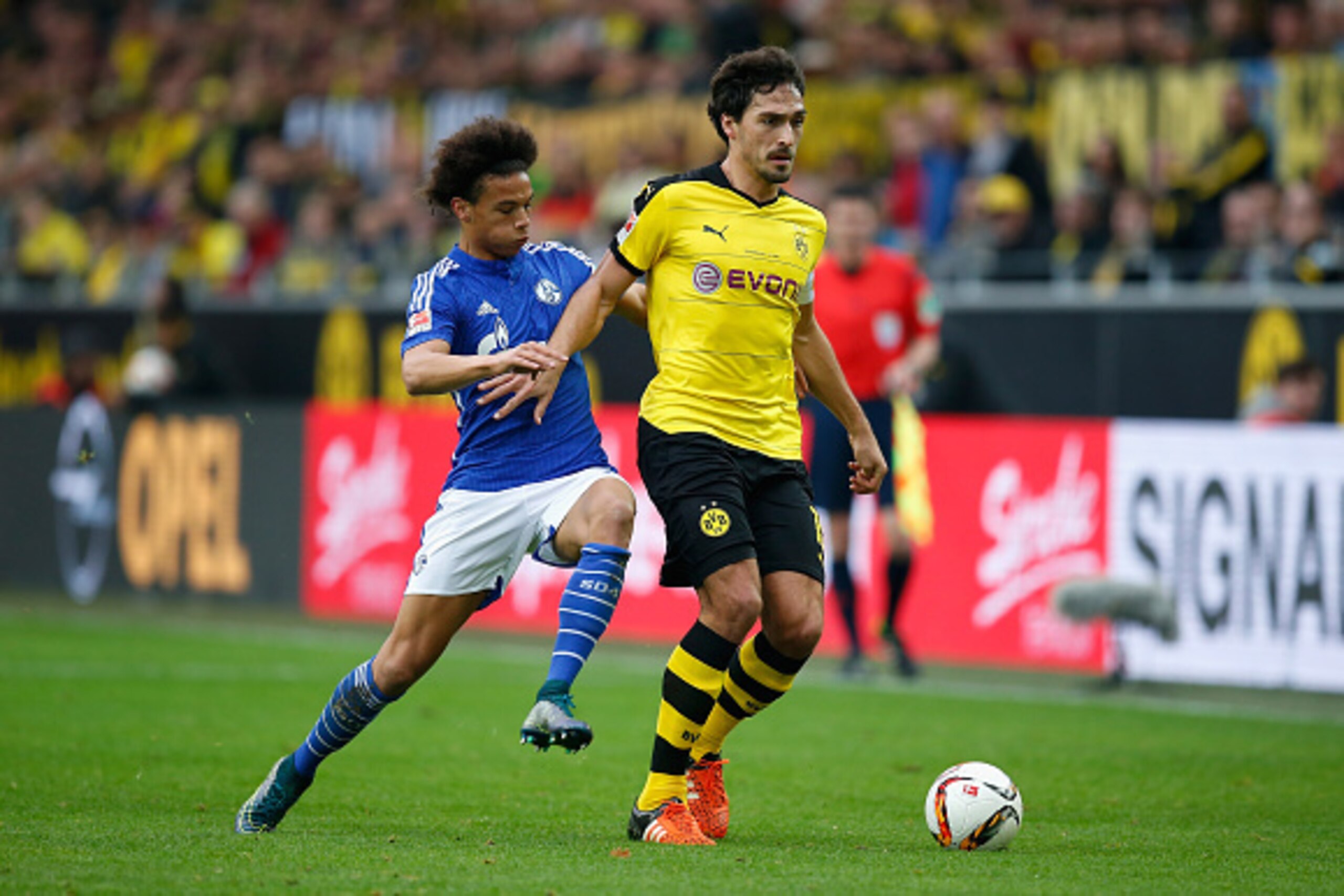 DORTMUND, GERMANY - NOVEMBER 08:  Leroy Sane (L) of Schalke challenges Mats Hummels of Dortmund during the Bundesliga match between Borussia Dortmund and FC Schalke 04 at Signal Iduna Park on November 8, 2015 in Dortmund, Germany.  (Photo by Boris Streube