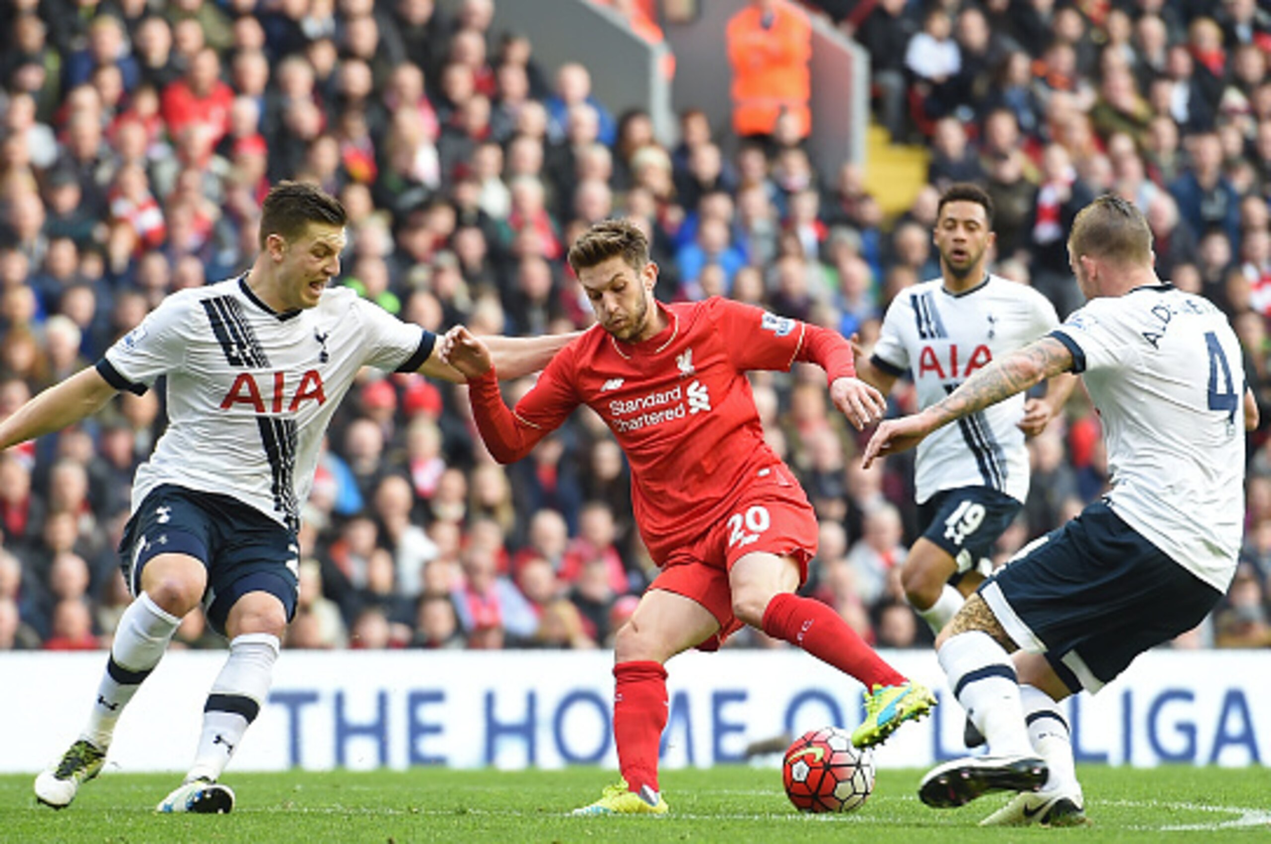 Liverpool's English midfielder Adam Lallana (C) vies with Tottenham Hotspur's Austrian defender Kevin Wimmer (L) and Tottenham Hotspur's Belgian defender Toby Alderweireld (R) during the English Premier League football match between Liverpool and Tottenha