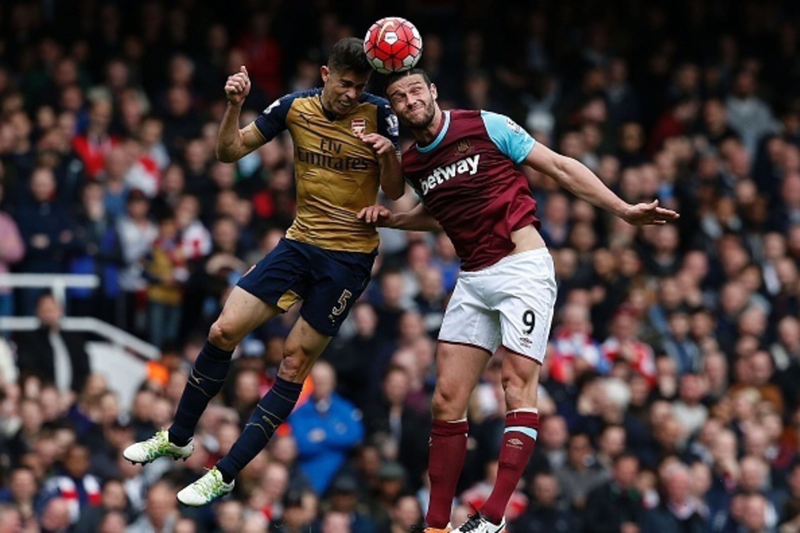 Arsenal's Brazilian defender Gabriel (L) vies in the air with West Ham United's English striker Andy Carroll during the English Premier League football match between West Ham United and Arsenal at The Boleyn Ground in Upton Park, in east London on April 9