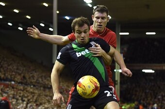 Liverpool's English midfielder James Milner (R) vies with Stoke City's Swiss forward Xherdan Shaqiri during the English League Cup semi-final second leg football match between Liverpool and Stoke City at Anfield in Liverpool, north west England, on Januar