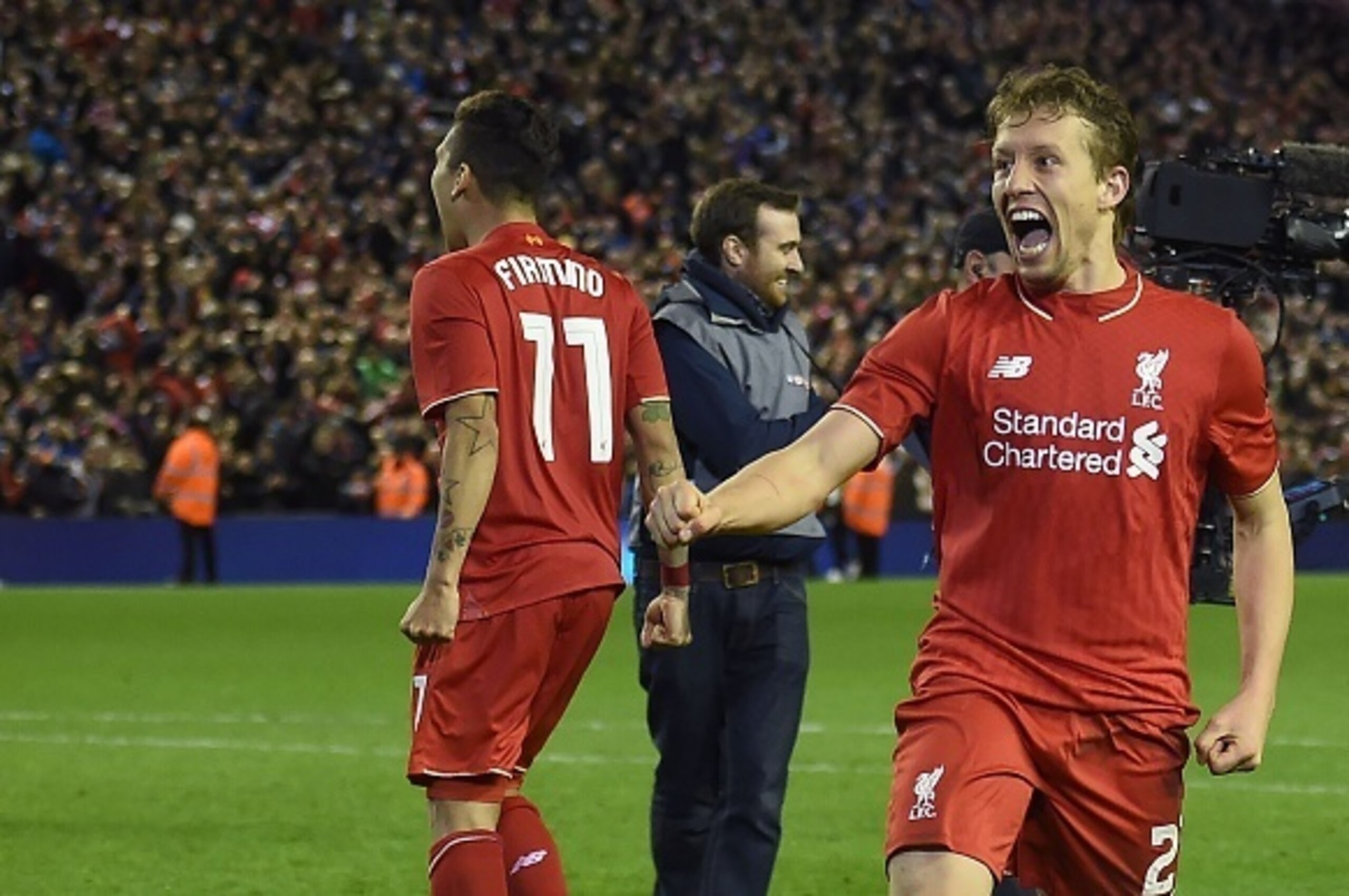 Liverpool's Brazilian midfielder Roberto Firmino (L) and Liverpool's Brazilian midfielder Lucas Leiva  celebrate on the pitch after winning the penalty shoot-out in the English League Cup semi-final second leg football match between Liverpool and Stoke Ci