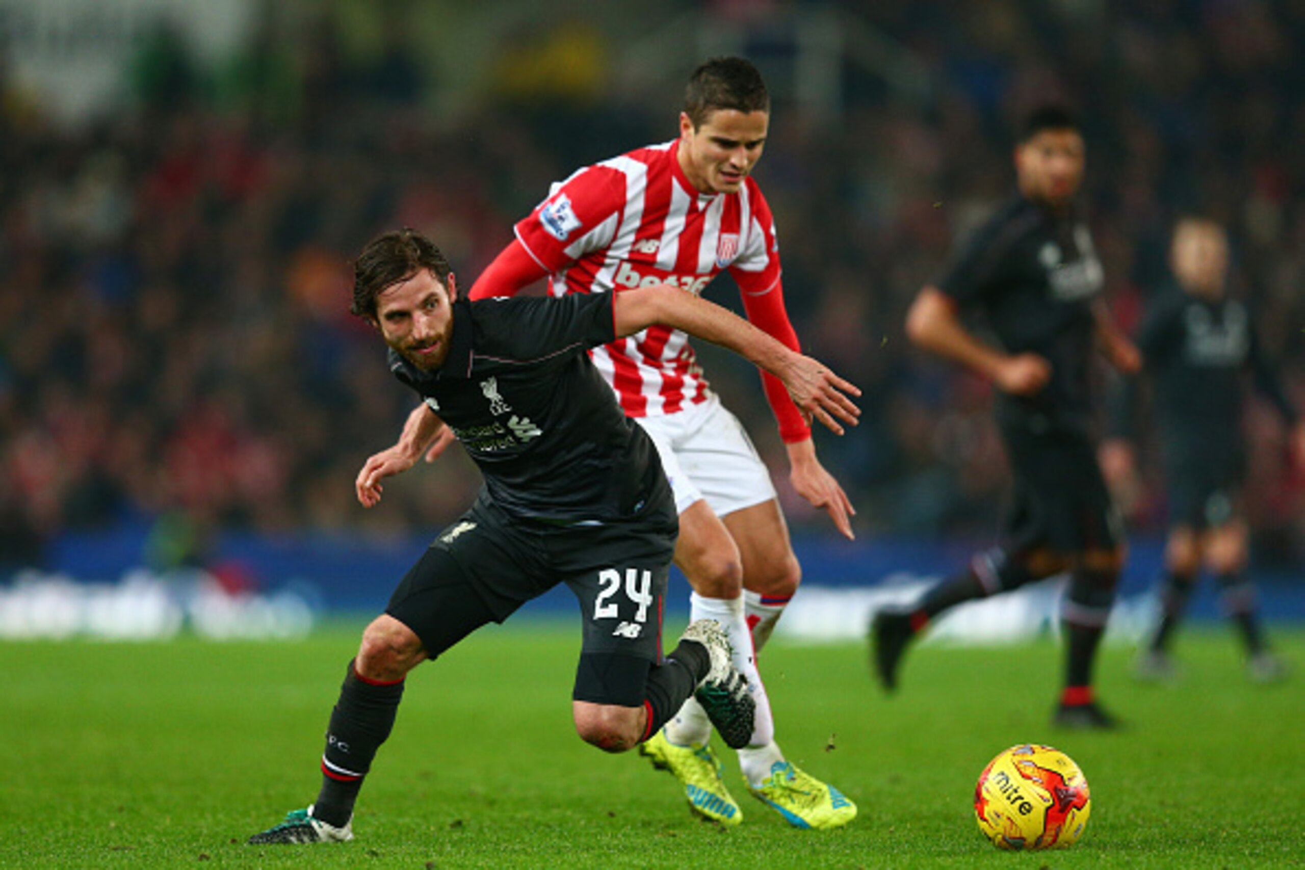 STOKE ON TRENT, ENGLAND - JANUARY 05:  Joe Allen of Liverpool and Ibrahim Afellay of Stoke City compete for the ball during the Capital One Cup semi final, first leg match between Stoke City and Liverpool at the Britannia Stadium on January 5, 2016 in Sto