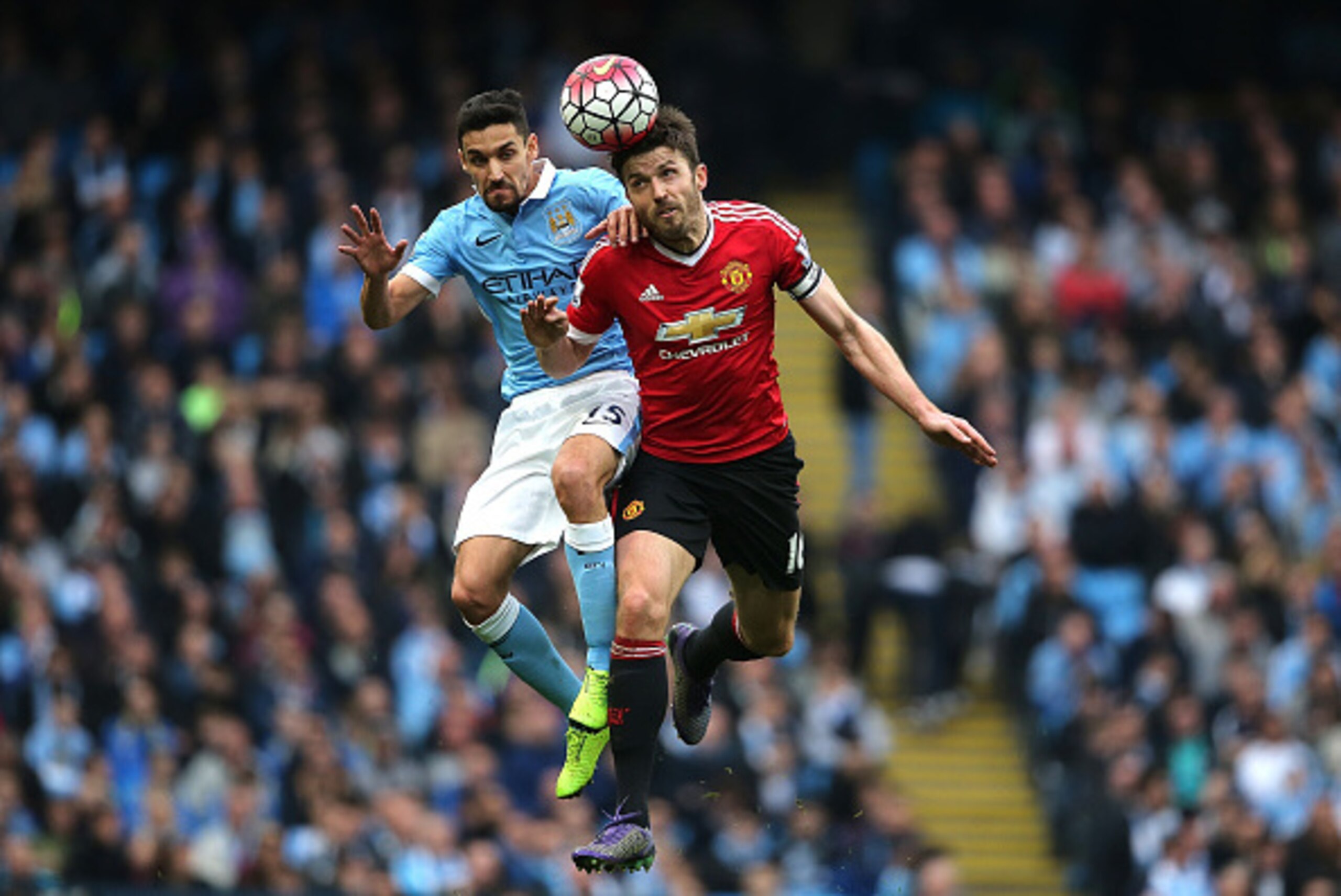MANCHESTER, ENGLAND - MARCH 20:  Jesus Navas of Manchester City competes with Michael Carrick of Manchester United during the Barclays Premier League match between Manchester City and Manchester United at the Etihad Stadium on March 20, 2016 in Manchester