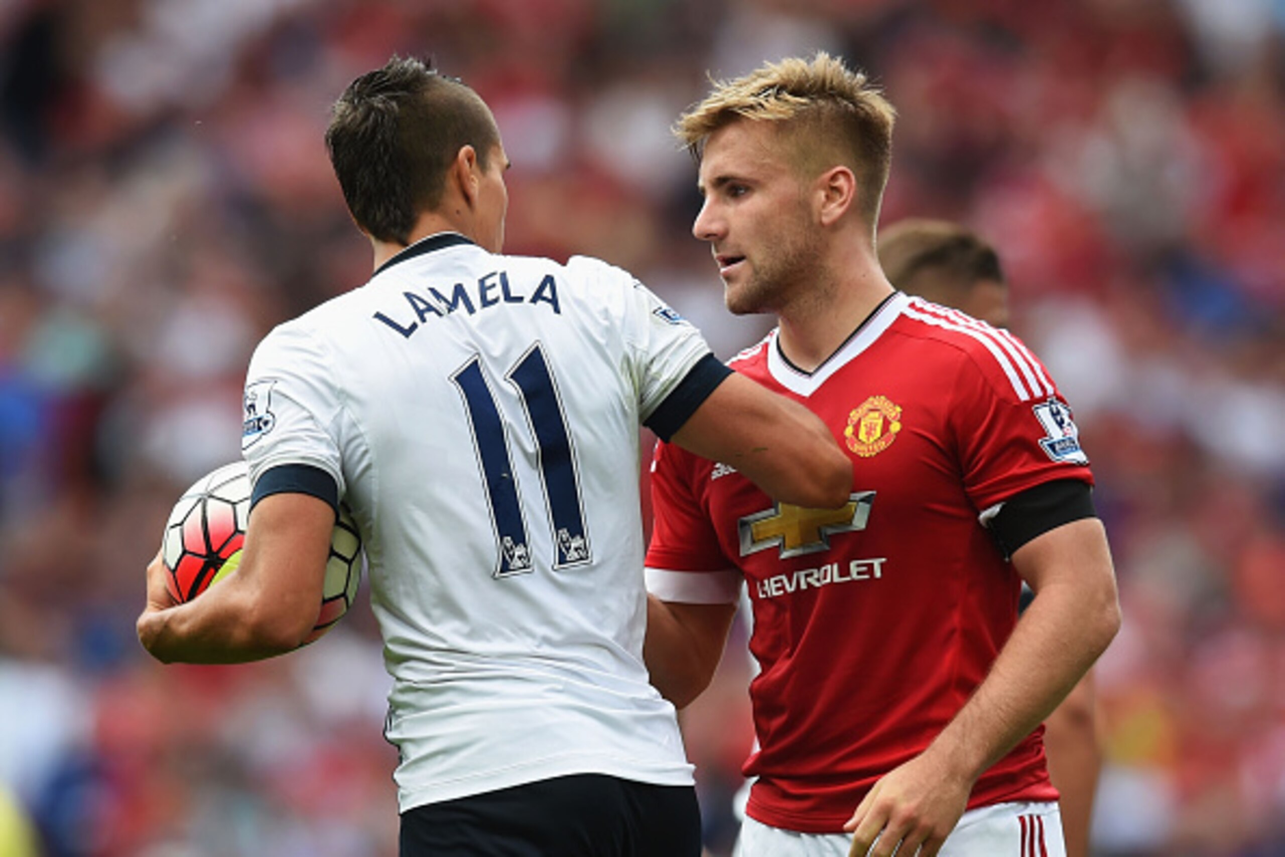 MANCHESTER, ENGLAND - AUGUST 08: Luke Shaw of Manchester United and Erik Lamela of Tottenham Hotspur argue during the Barclays Premier League match between Manchester United and Tottenham Hotspur at Old Trafford on August 8, 2015 in Manchester, England.  