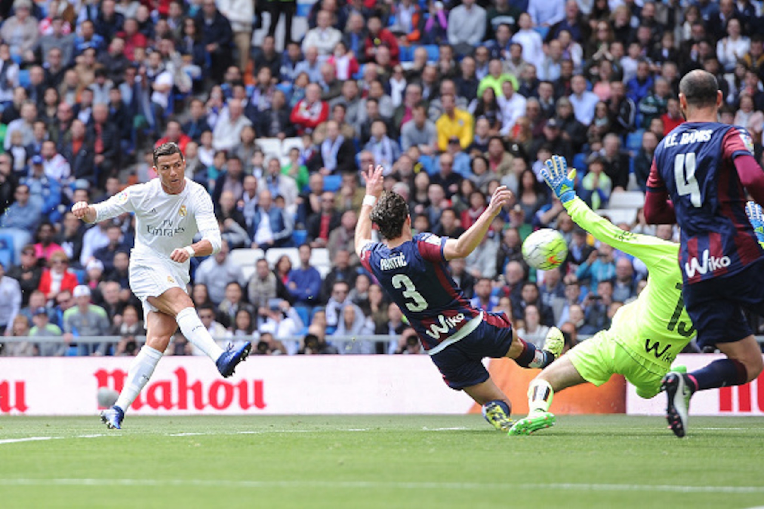MADRID, SPAIN - APRIL 09: Cristiano Ronaldo of Real Madrid shoots past Asier Riesgo to score his sid's 2rd goal during the La Liga match between Real Madrid and Eibar at Estadio Santiago Bernabeu on April 9, 2016 in Madrid, Spain.  (Photo by Denis Doyle/G