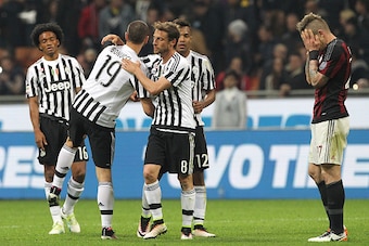 MILAN, ITALY - APRIL 09: Claudio Marchisio and Leonardo Bonucci #19 of Juventus FC celebrates a victory at the end of the Serie A match between AC Milan and Juventus FC at Stadio Giuseppe Meazza on April 9, 2016 in Milan, Italy. (Photo by Marco Luzzani/Ge