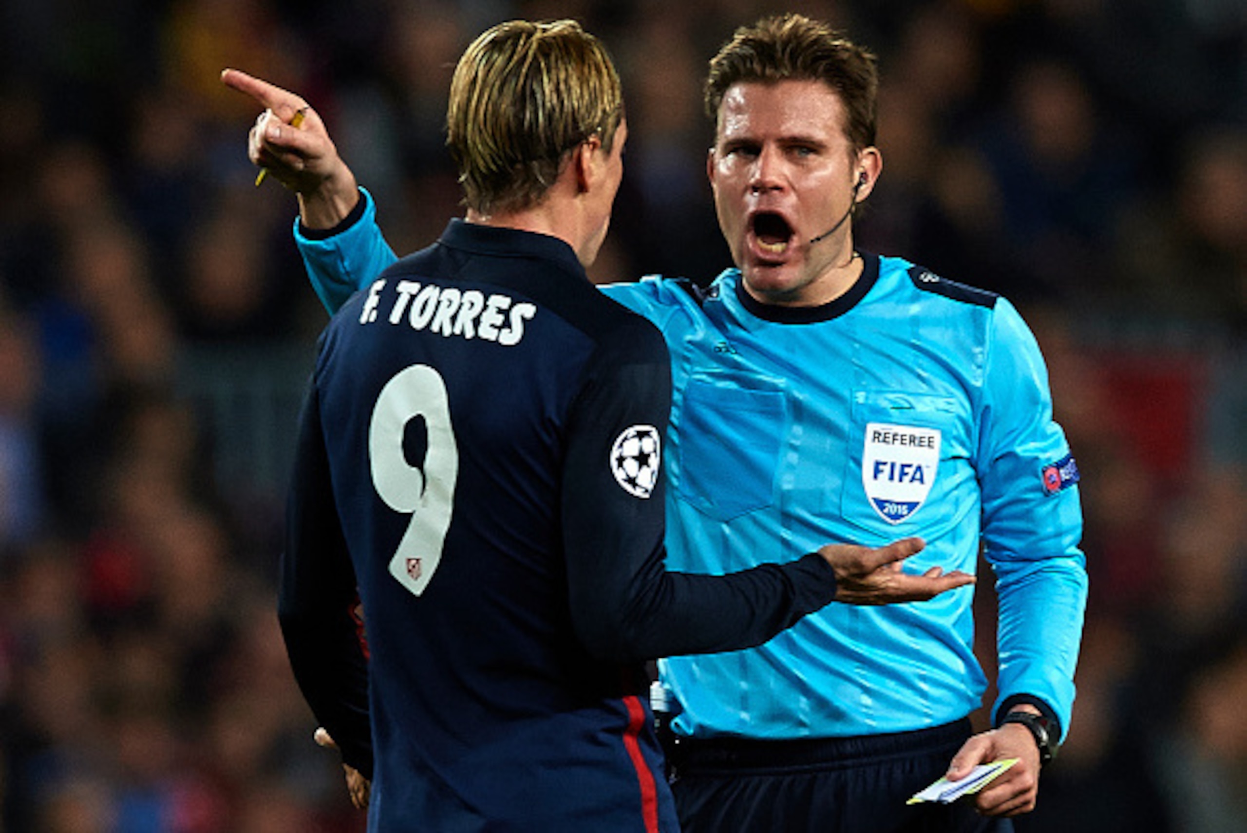 BARCELONA, SPAIN - APRIL 05:  Fernando Torres of Atletico Madrid is shown a yellow card by referee Felix Brych during the UEFA Champions League Quarter Final first leg match between FC Barcelona and Atletico de Madrid at Camp Nou on April 5, 2016 in Barce