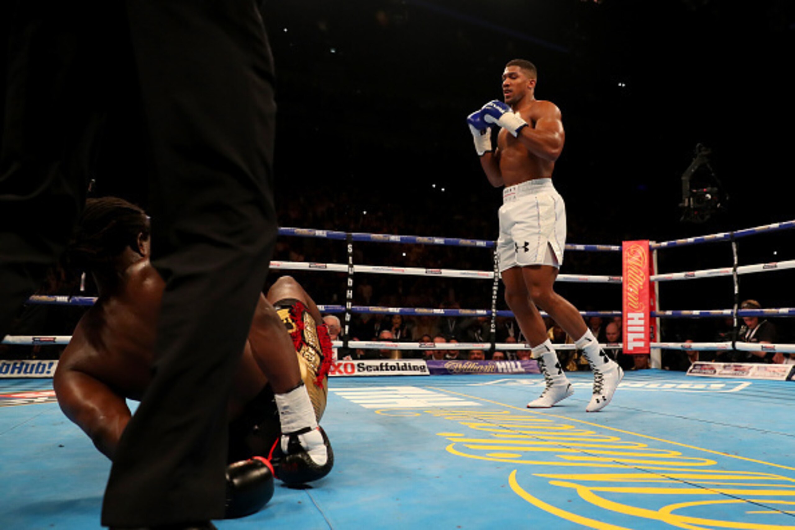 LONDON, ENGLAND - APRIL 09:  Anthony Joshua of England knocks Charles Martin of the United States to the canvas during the IBF World Heavyweight title fight at The O2 Arena on April 9, 2016 in London, England.  (Photo by Richard Heathcote/Getty Images)
