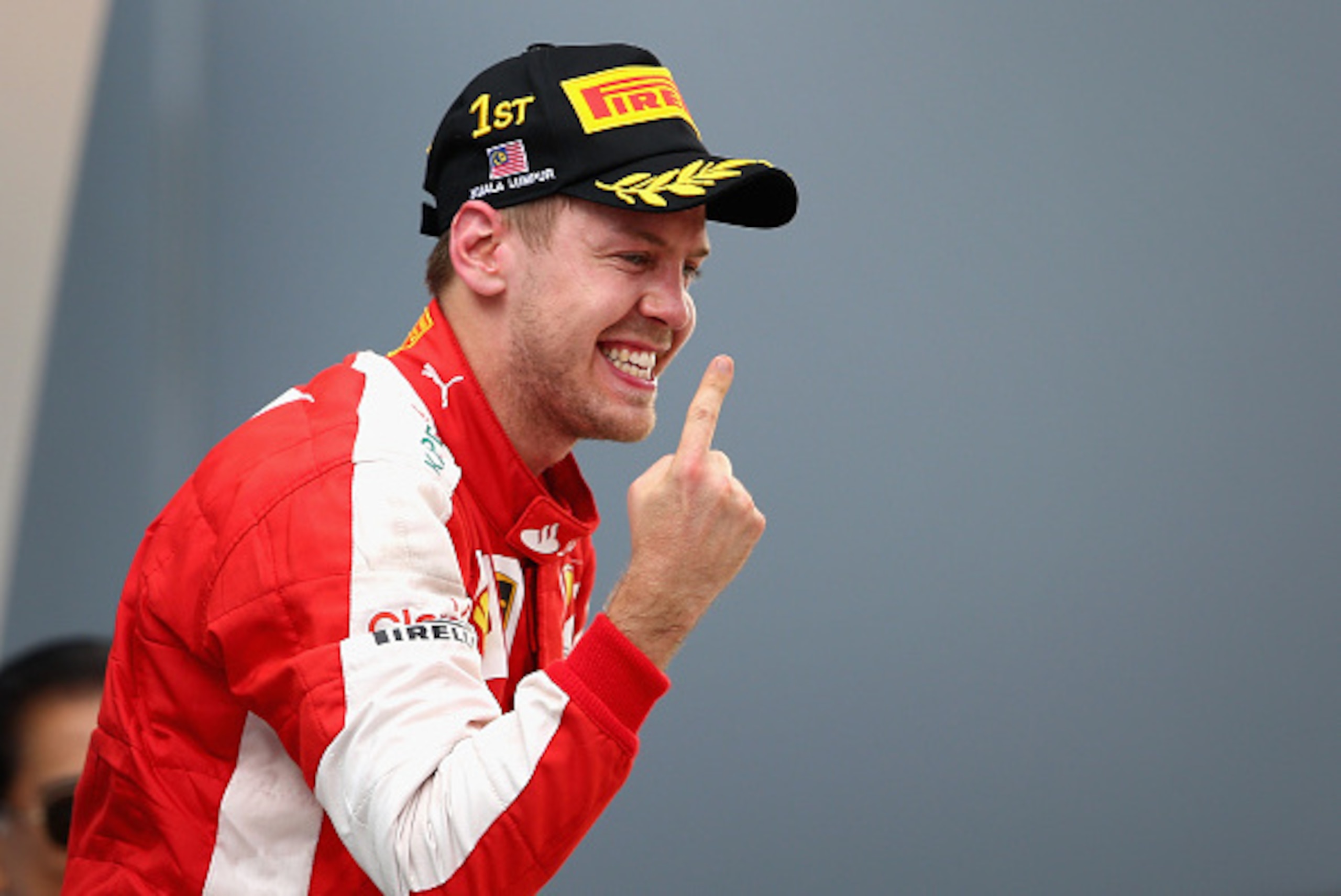 KUALA LUMPUR, MALAYSIA - MARCH 29:  Sebastian Vettel of Germany and Ferrari celebrates on the podium after winning the Malaysia Formula One Grand Prix at Sepang Circuit on March 29, 2015 in Kuala Lumpur, Malaysia.  (Photo by Clive Mason/Getty Images)