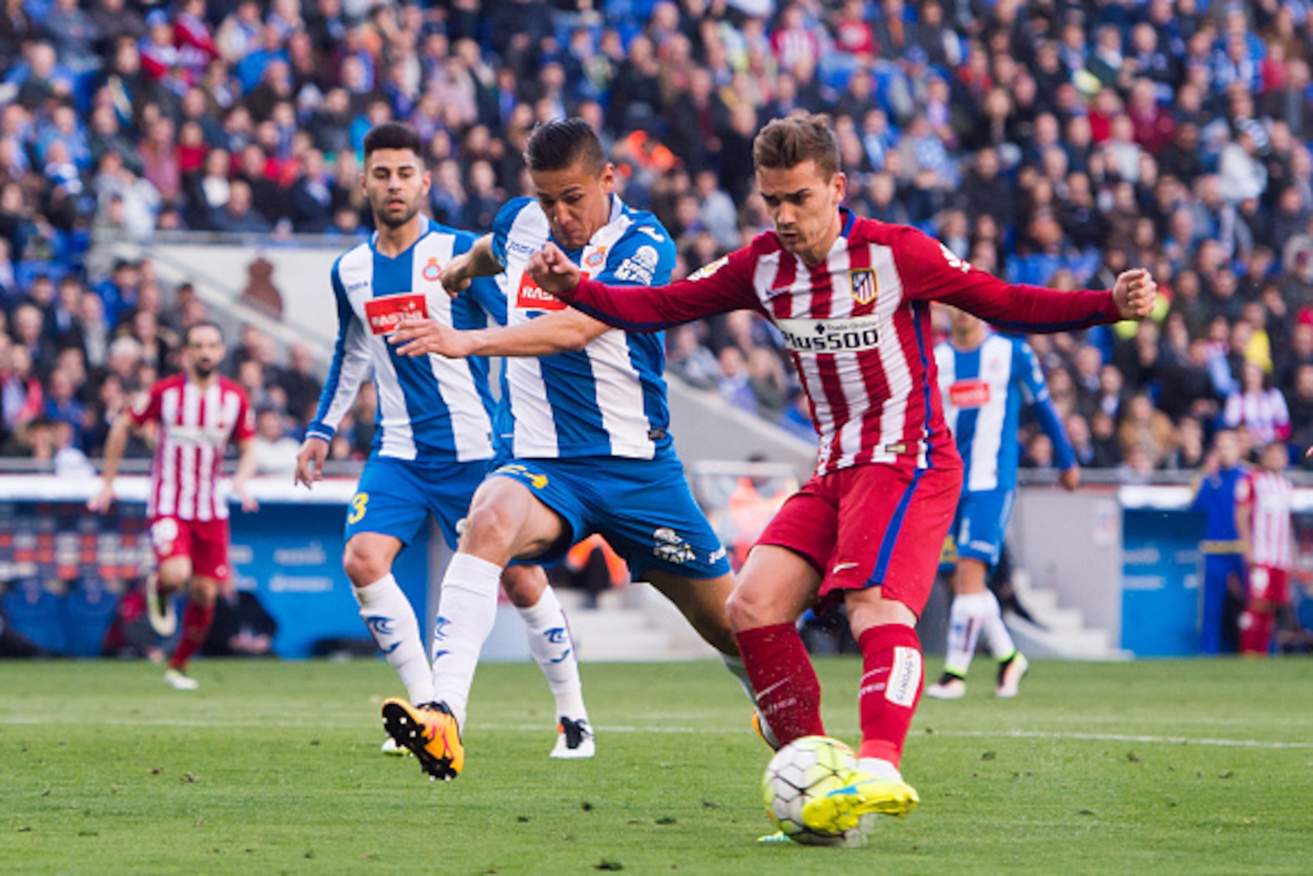 BARCELONA, SPAIN - APRIL 09: Antoine Griezmann of Club Atletico de Madrid shoots towards goal next to Oscar Duarte (L) of Real CD Espanyol and scores his team's second goal during the La Liga match between Real CD Espanyol and Club Atletico de Madrid at C BARCELONA, SPAIN - APRIL 09: Antoine Griezmann of Club Atletico de Madrid shoots towards goal next to Oscar Duarte (L) of Real CD Espanyol and scores his team's second goal during the La Liga match between Real CD Espanyol and Club Atletico de Madrid at C