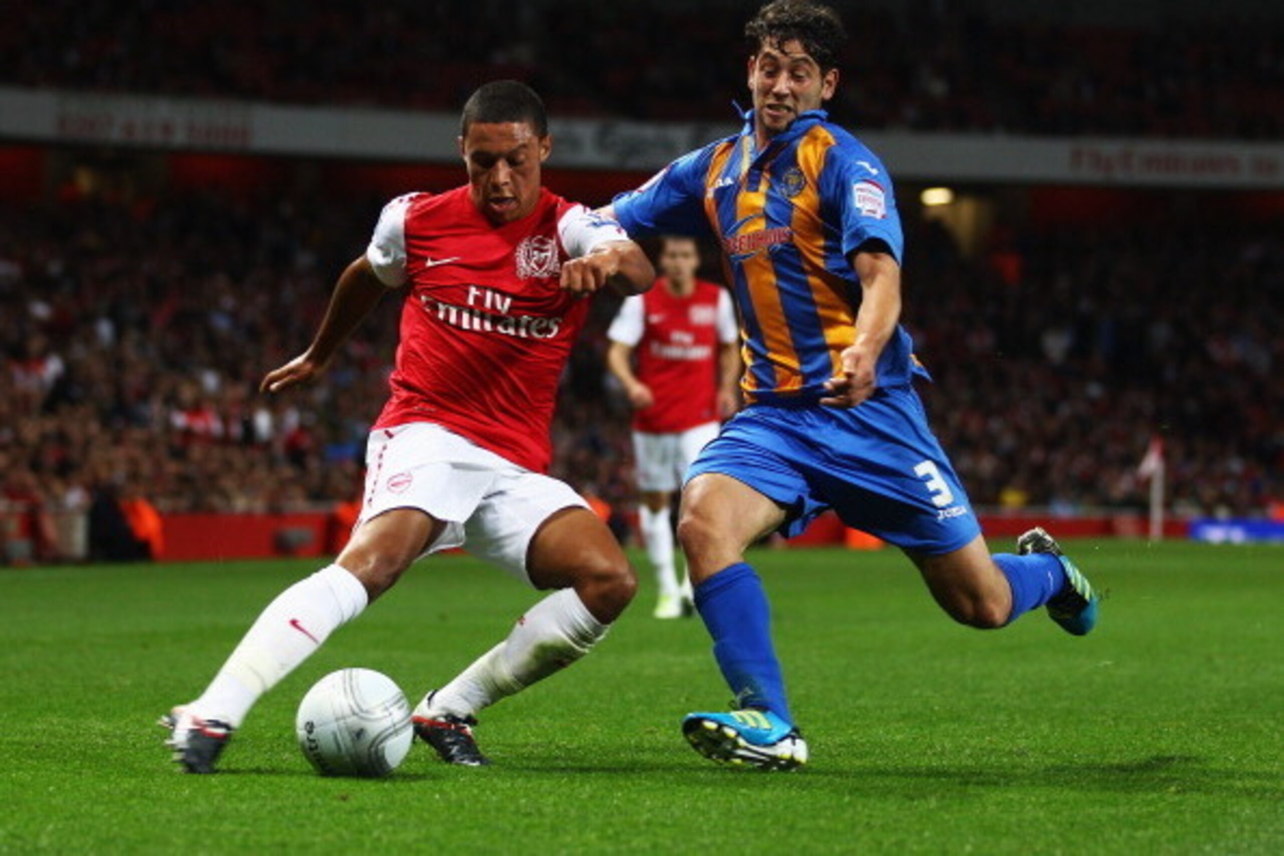 LONDON, ENGLAND - SEPTEMBER 20:  Alex Oxlade-Chamberlain of Arsenal takes on Joe Jacobson of Shrewsbury Town during the Carling Cup Third Round match between Arsenal and Shrewsbury Town at Emirates Stadium on September 20, 2011 in London, England.  (Photo