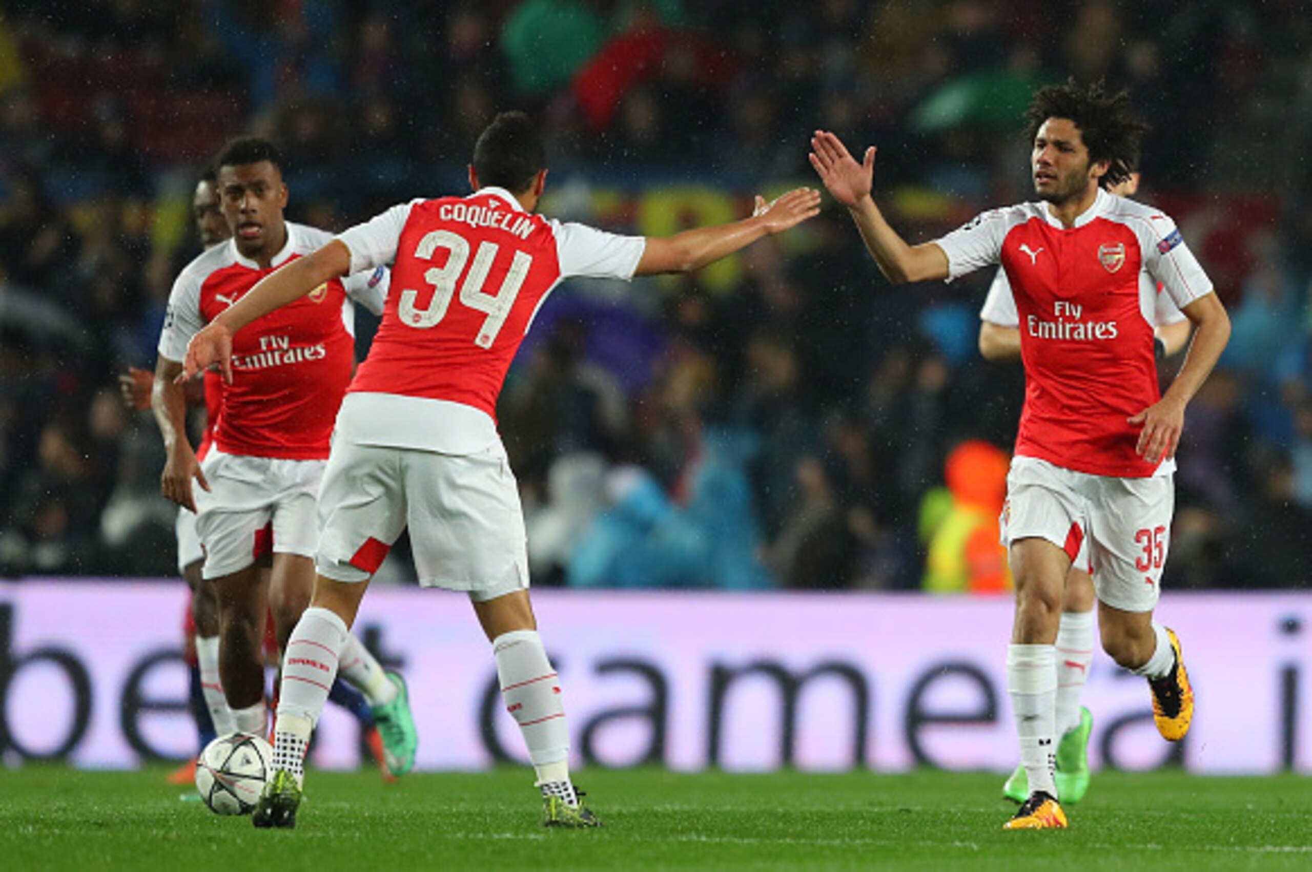 BARCELONA, SPAIN - MARCH 16: Mohamed Elneny (R) of Arsenal celebrates scoring his team's first goal with his team mate Francis Coquelin (C) during the UEFA Champions League round of 16, second Leg match between FC Barcelona and Arsenal FC at Camp Nou on M