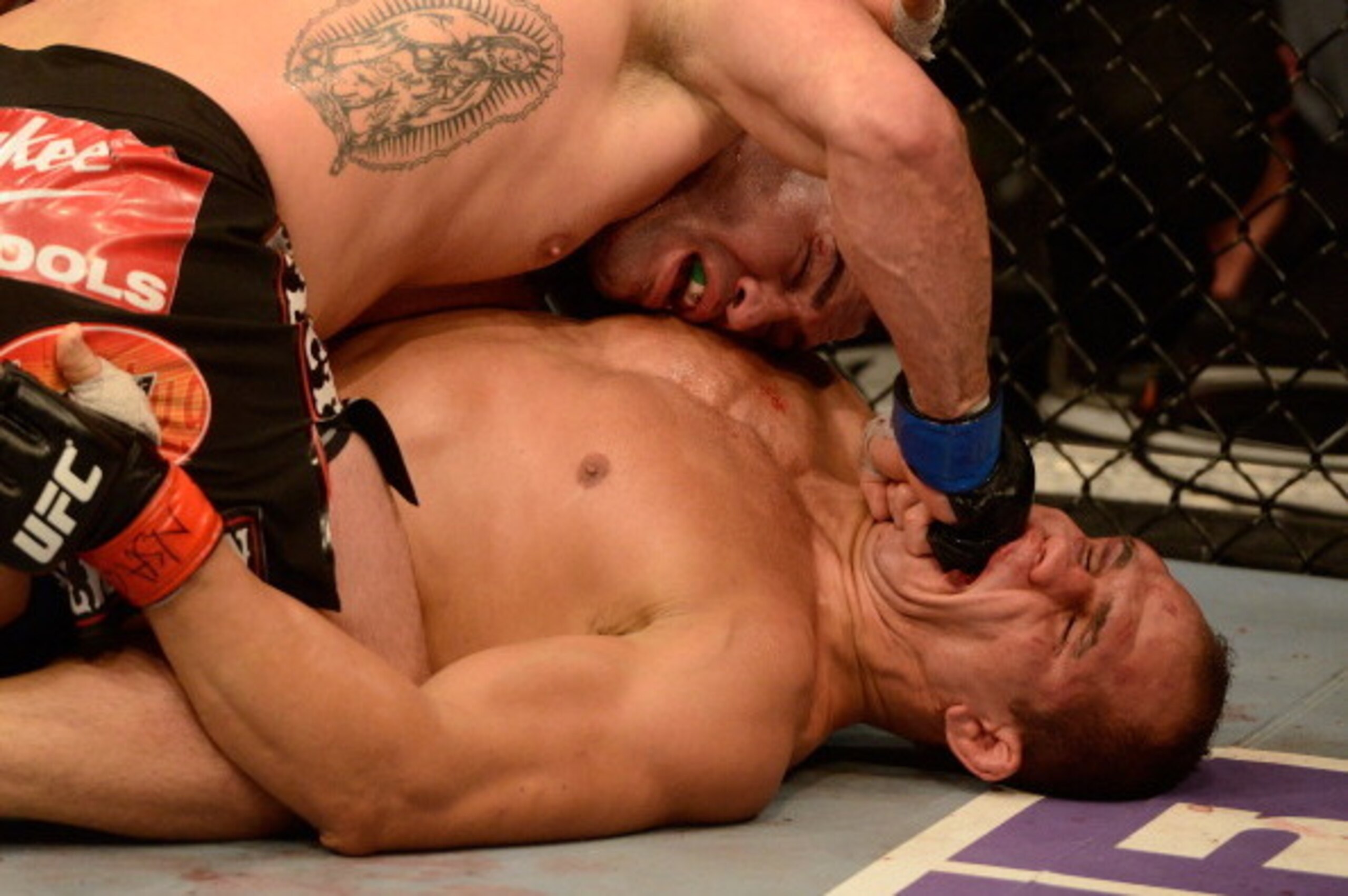 LAS VEGAS, NV - DECEMBER 29:  Cain Velasquez (top) punches Junior dos Santos during their heavyweight championship fight at UFC 155 on December 29, 2012 at MGM Grand Garden Arena in Las Vegas, Nevada. (Photo by Donald Miralle/Zuffa LLC/Zuffa LLC via Getty