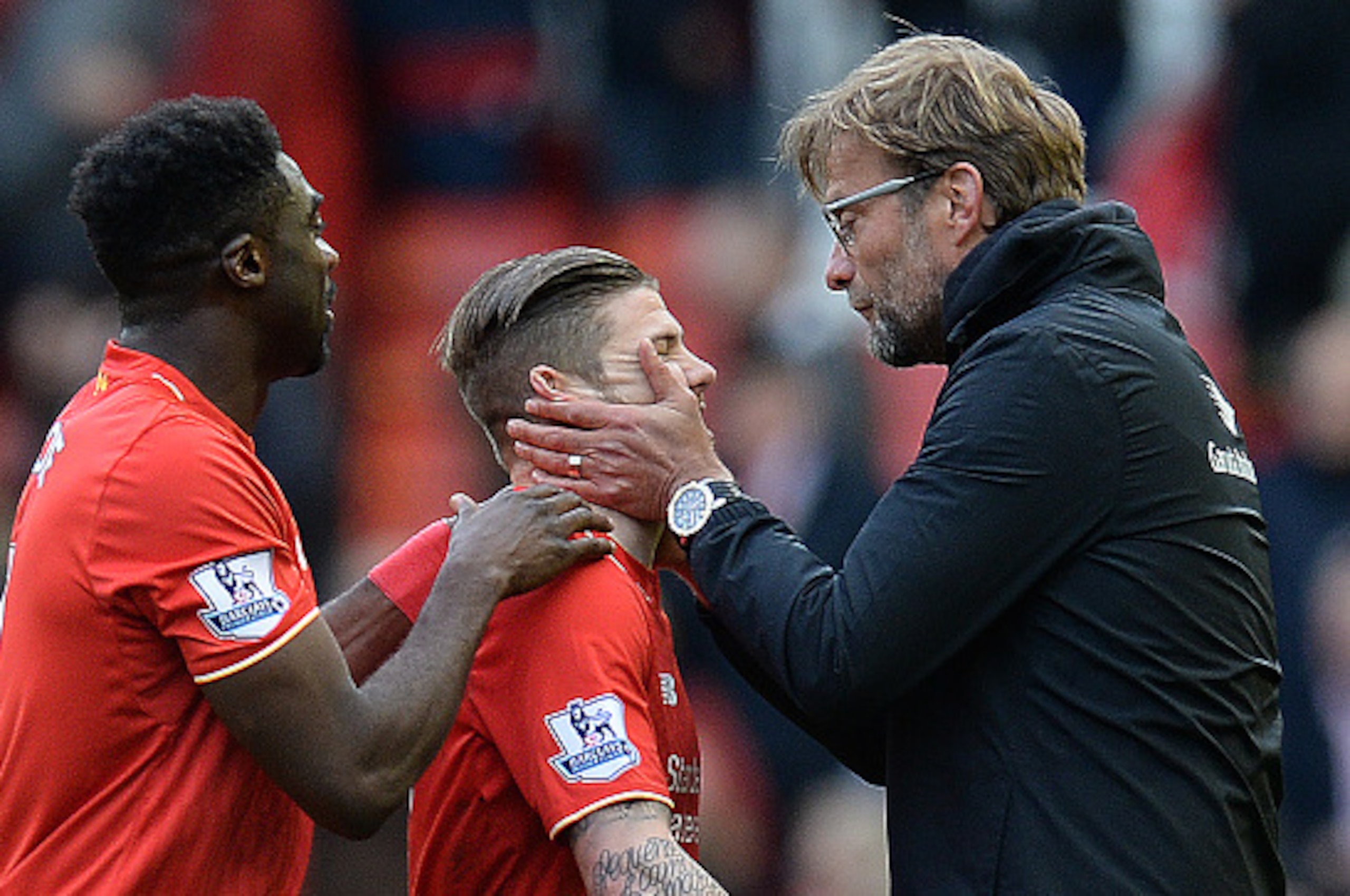Liverpool's German manager Jurgen Klopp congratulates Liverpool's Spanish defender Alberto Moreno (C) following the English Premier League football match between Liverpool and Stoke City at Anfield in Liverpool, northwest England on April 10, 2016.
Liverp