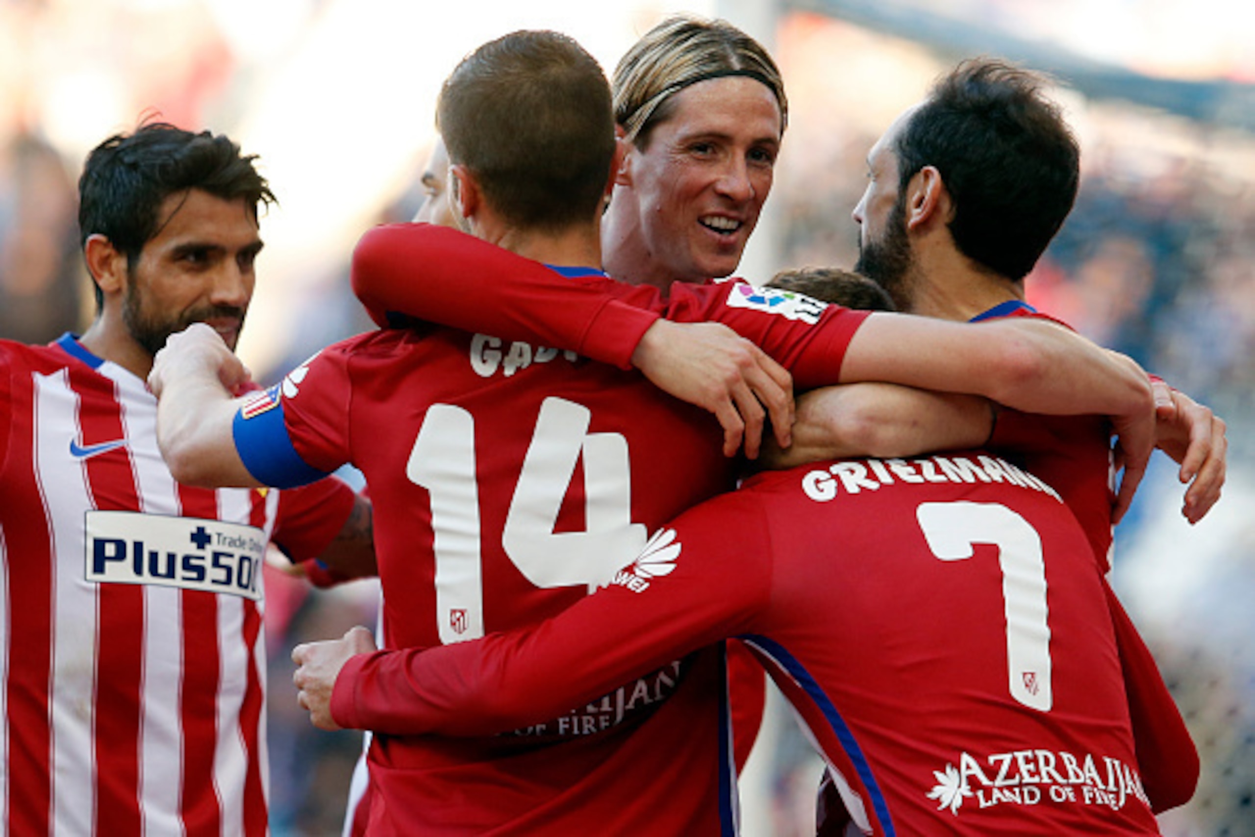 Atletico Madrid's French forward Antoine Griezmann (R) celebrates a goal with Atletico Madrid's forward Fernando Torres (3rd R) and other teammates during the Spanish league football match RCD Espanyol vs Club Atletico de Madrid at the Cornella-El Prat st
