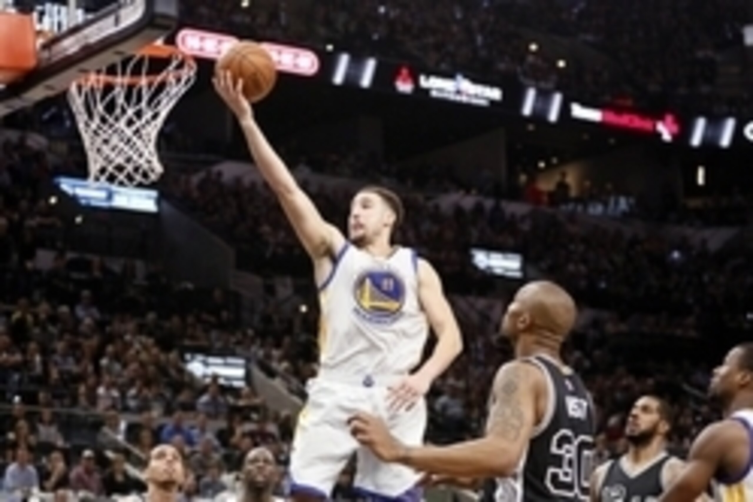 Apr 10, 2016; San Antonio, TX, USA; Golden State Warriors shooting guard Klay Thompson (11) shoots the ball as San Antonio Spurs power forward David West (30) looks on during the second half at AT&T Center. Mandatory Credit: Soobum Im-USA TODAY Sports