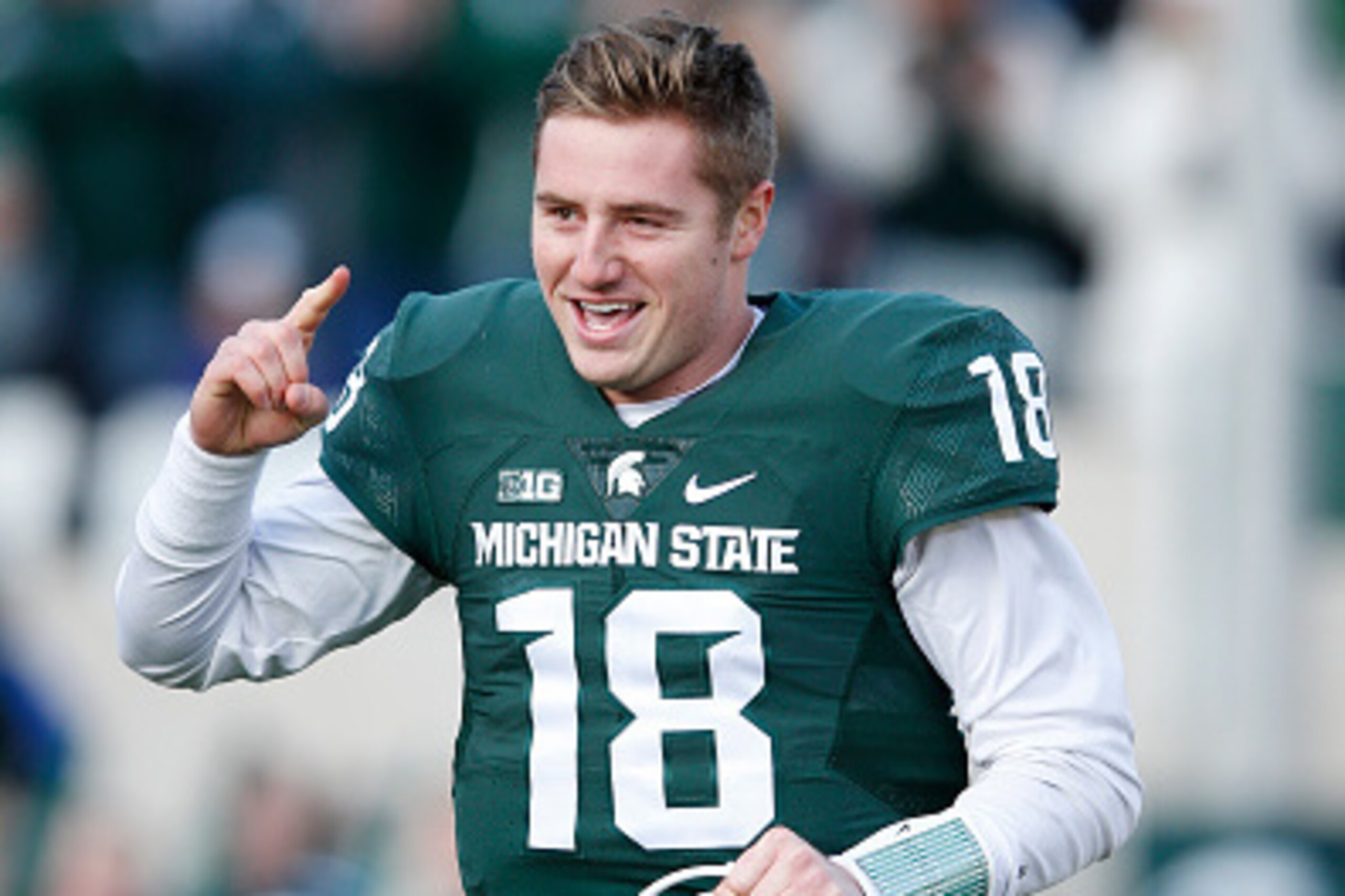 EAST LANSING, MI - NOVEMBER 28: Connor Cook #18 of the Michigan State Spartans runs onto the field before the game against the Penn State Nittany Lions at Spartan Stadium on November 28, 2015 in East Lansing, Michigan. Michigan State defeated Penn State 5