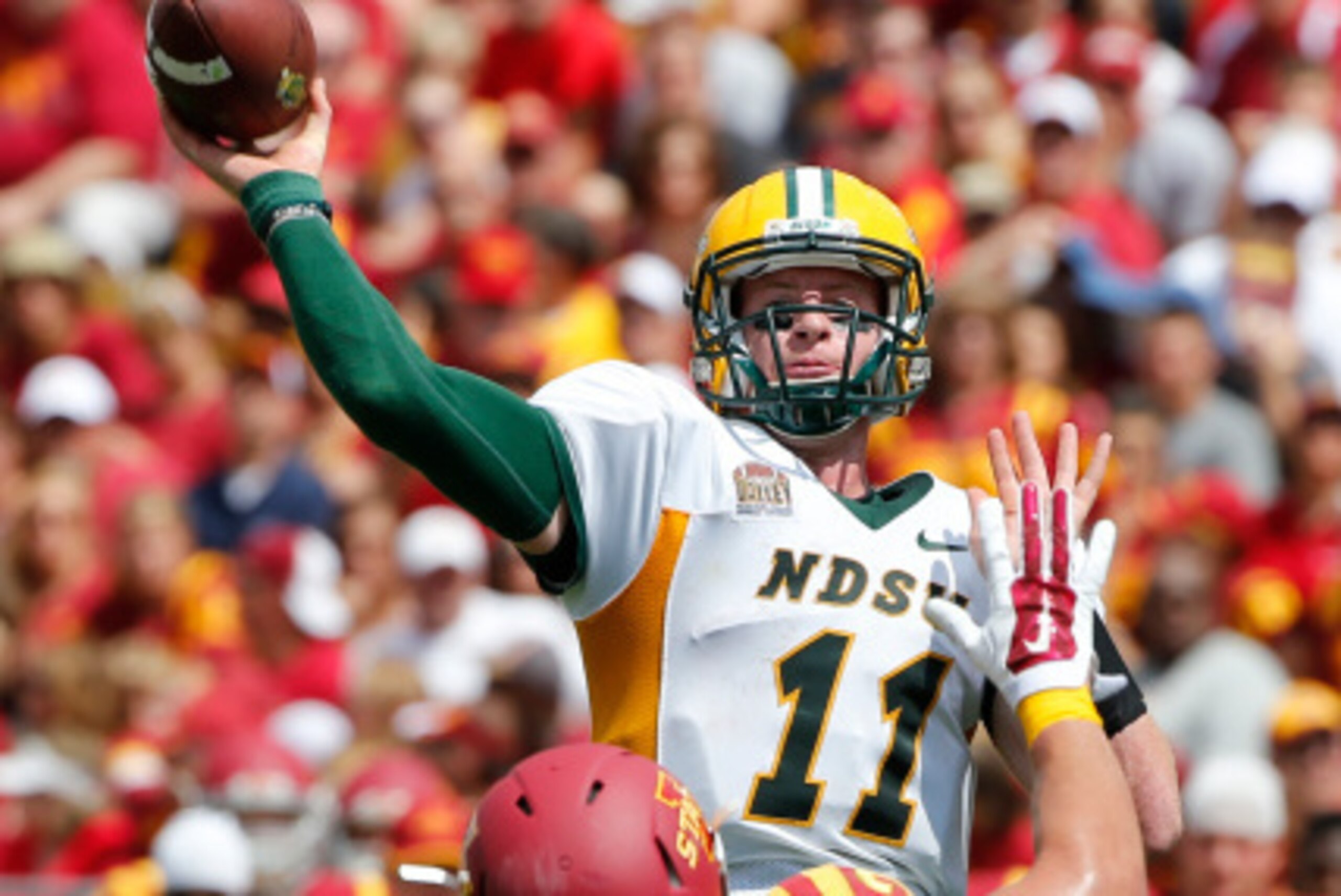 AMES, IA Ð AUGUST 30: Quarterback Carson Wentz #11 of the North Dakota State Bison throws under pressure from linebacker Kane Seeley #29 of the Iowa State Cyclones in the second half of play at Jack Trice Stadium on August 30, 2014 in Ames, Iowa. North Da