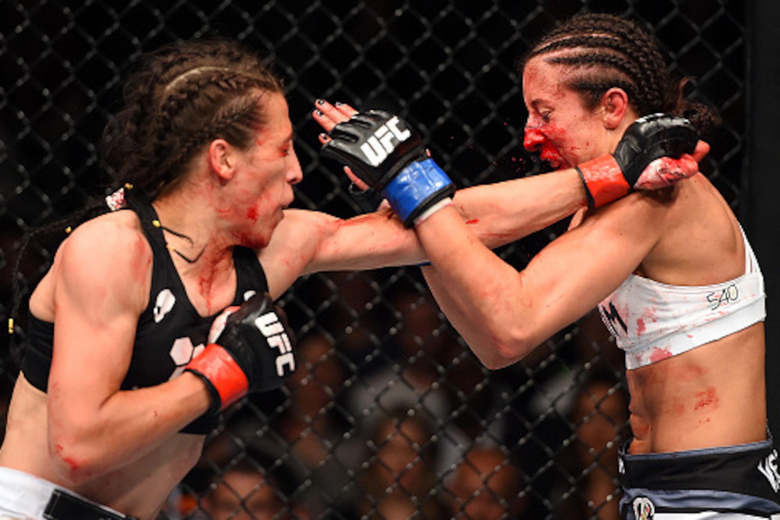 BERLIN, GERMANY - JUNE 20:  (L-R) Joanna Jedrzejczyk of Poland punches Jessica Penne of the United States in their women's strawweight championship bout during the UFC Fight Night event at the O2 World on June 20, 2015 in Berlin, Germany. (Photo by Josh H