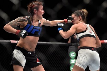 Jul 18, 2015; Glasgow, Lanarkshire, Scotland; Joanne Calderwood (red gloves) connects with a left to the nose of Courtney Casey (blue gloves) during their bout at The SSE Hydro. Mandatory Credit: Steve Flynn-USA TODAY Sports