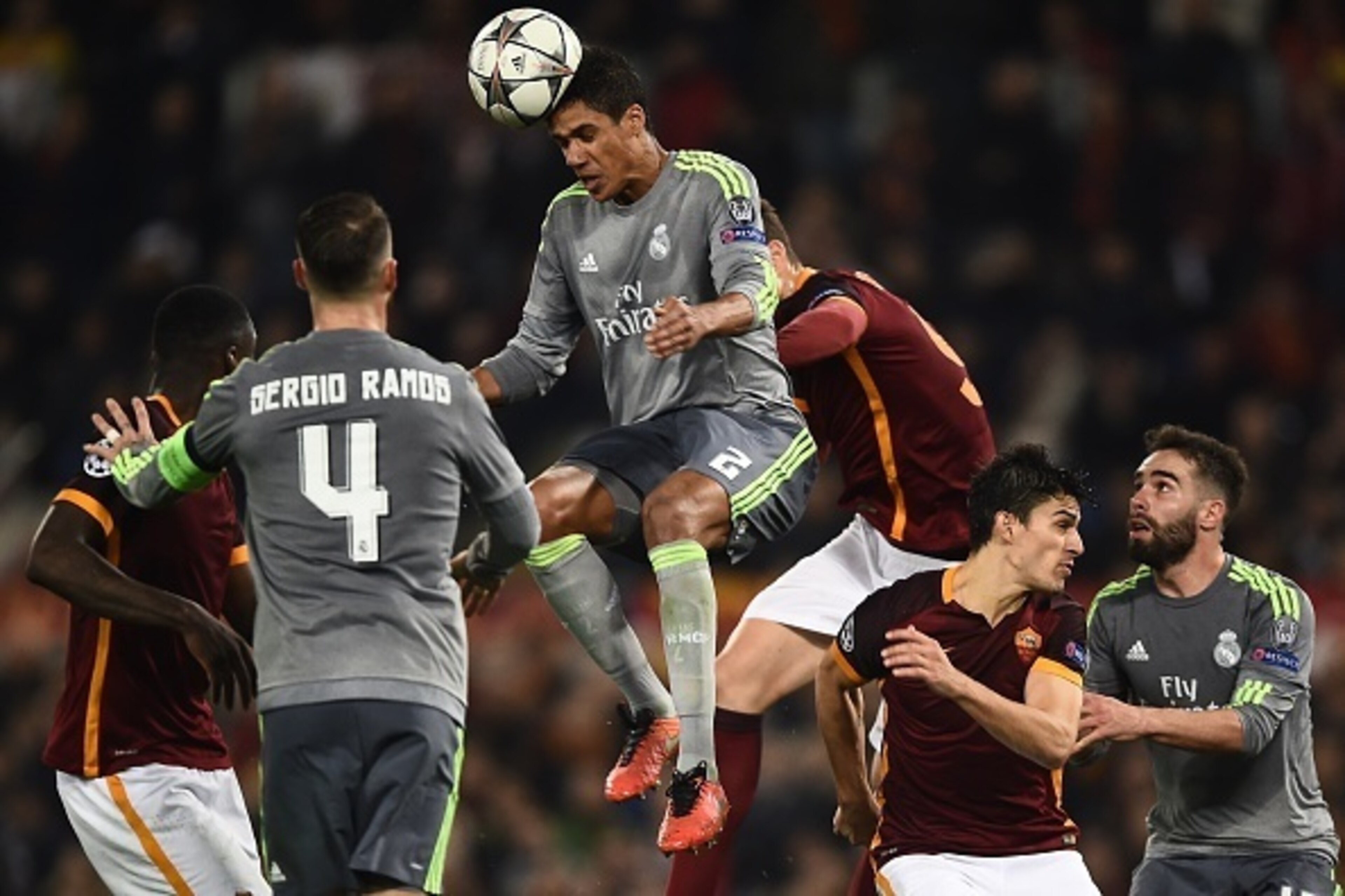 Real Madrid's French defender Raphael Varane (C) heads the ball during the UEFA Champions League football match AS Roma vs Real Madrid on Frebruary 17, 2016 at the Olympic stadium in Rome.  Real Madrid won 0- 2.  AFP PHOTO / FILIPPO MONTEFORTE / AFP / FIL