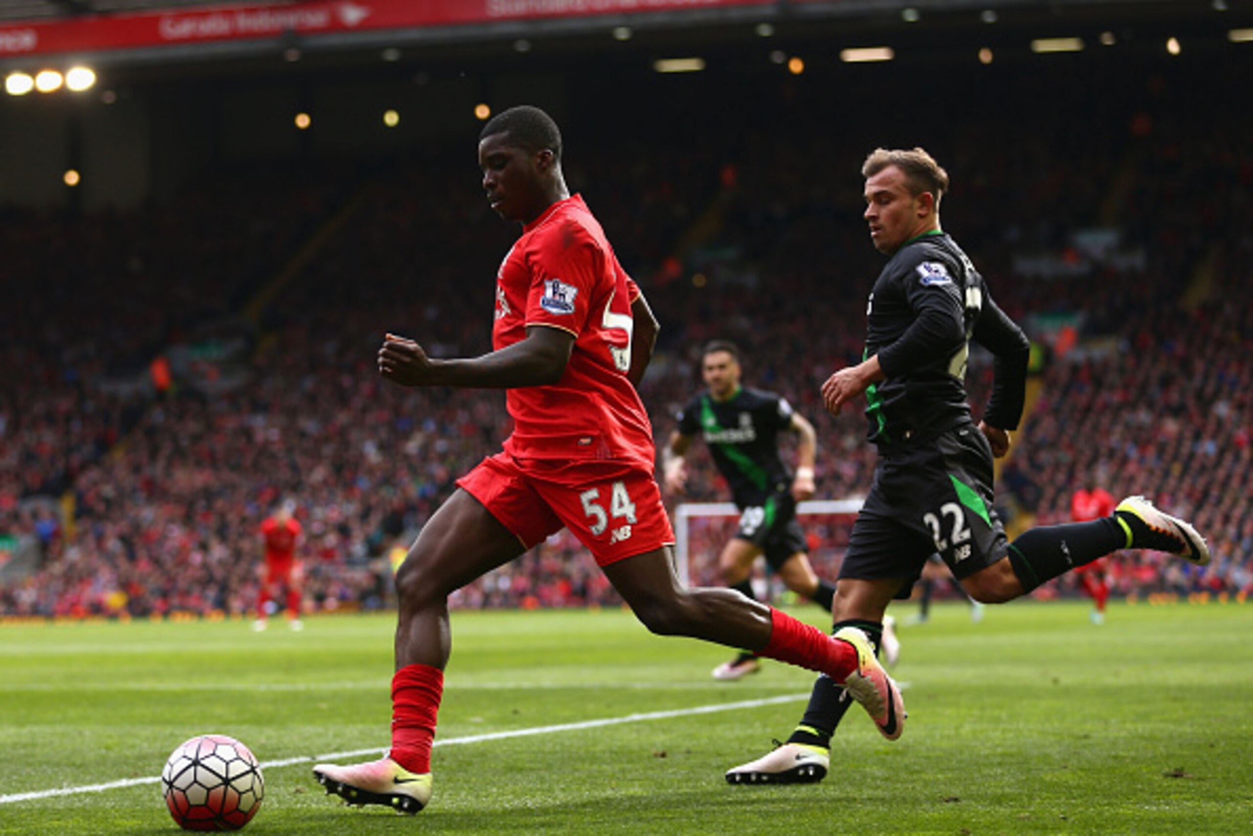 LIVERPOOL, UNITED KINGDOM - APRIL 10:  Sheyi Ojo of Liverpool is chased by Xherdan Shaqiri of Stoke City during the Barclays Premier League match between Liverpool and Stoke City at Anfield on April 10, 2016 in Liverpool, England.  (Photo by Clive Brunski