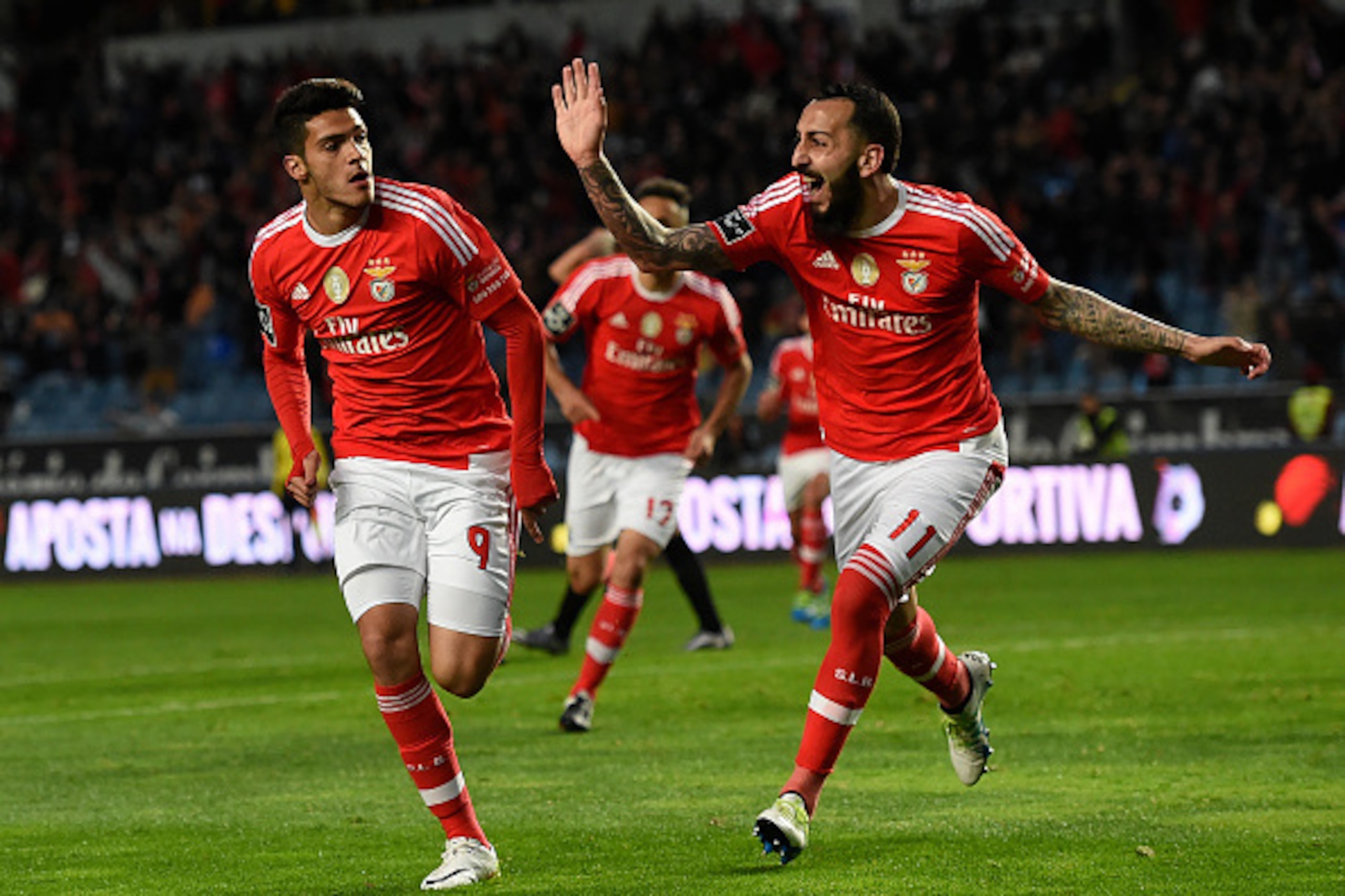 Benfica's Mexican forward Raul Jimenez (L) celebrates with teammate Greek forward Konstantinos Mitroglou after scoring a goal during the Portuguese league football match Associacao Academica de Coimbra vs SL Benfica at the City of Coimbra stadium in Coimb