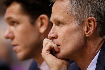 PHOENIX, AZ - FEBRUARY 10:  Head coach Steve Kerr (R) of the Golden State Warriors looks on from the bench alongside assistant coach Luke Walton during the NBA game against the Phoenix Suns at Talking Stick Resort Arena on February 10, 2016 in Phoenix, Ar