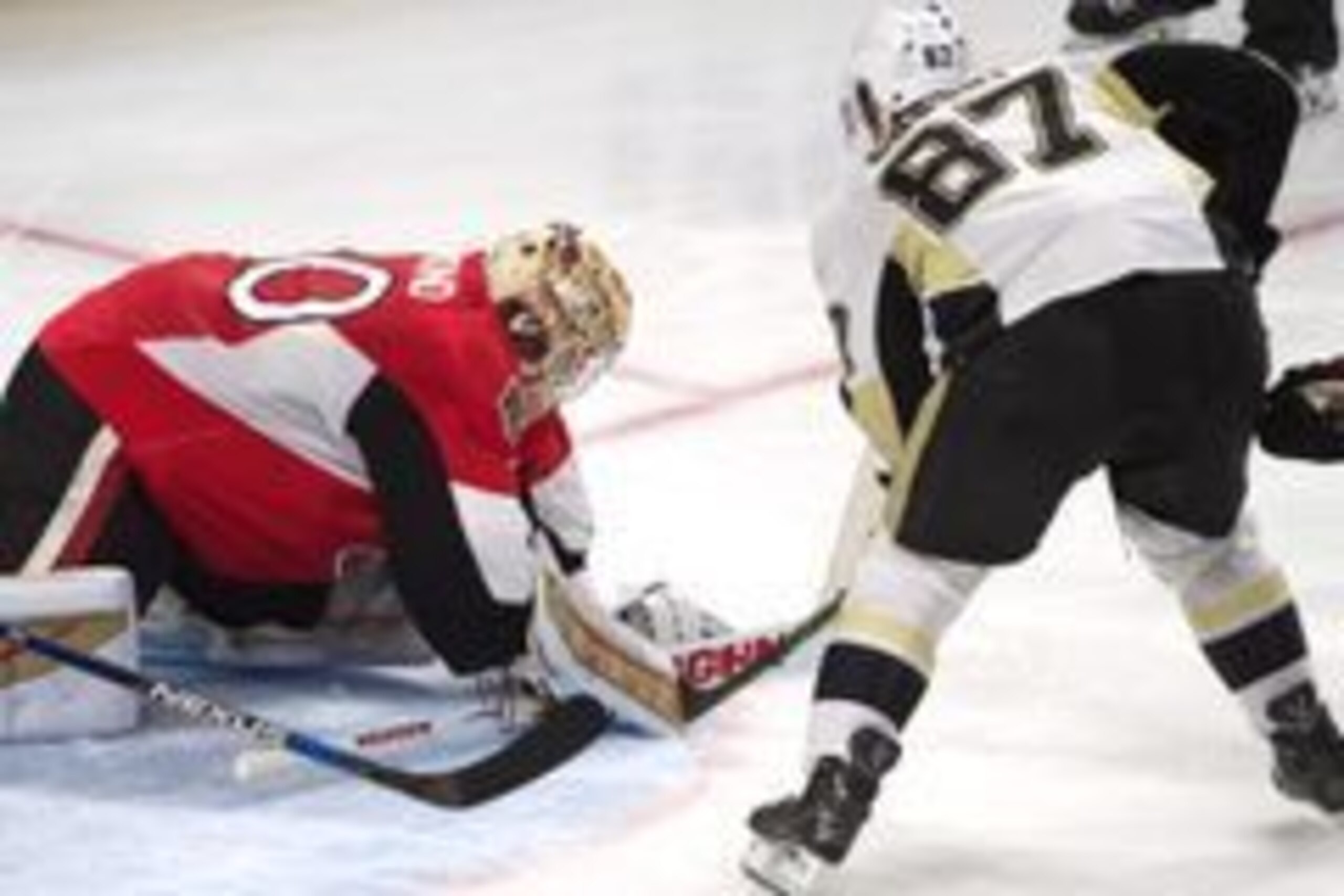 Apr 5, 2016; Ottawa, Ontario, CAN; Ottawa Senators goalie Andrew Hammond (30) makes a save in front of Pittsburgh Penguins center Sidney Crosby (87) in the third period at the Canadian Tire Centre. The Penguins defeated the Senators 5-3. Mandatory Credit: