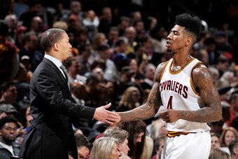 CLEVELAND, OH - MARCH 16: Tyronn Lue of the Cleveland Cavaliers high fives Iman Shumpert #4 of the Cleveland Cavaliers during the game against the Dallas Mavericks on March 16, 2016 at Quicken Loans Arena in Cleveland, Ohio.  NOTE TO USER: User expressly 