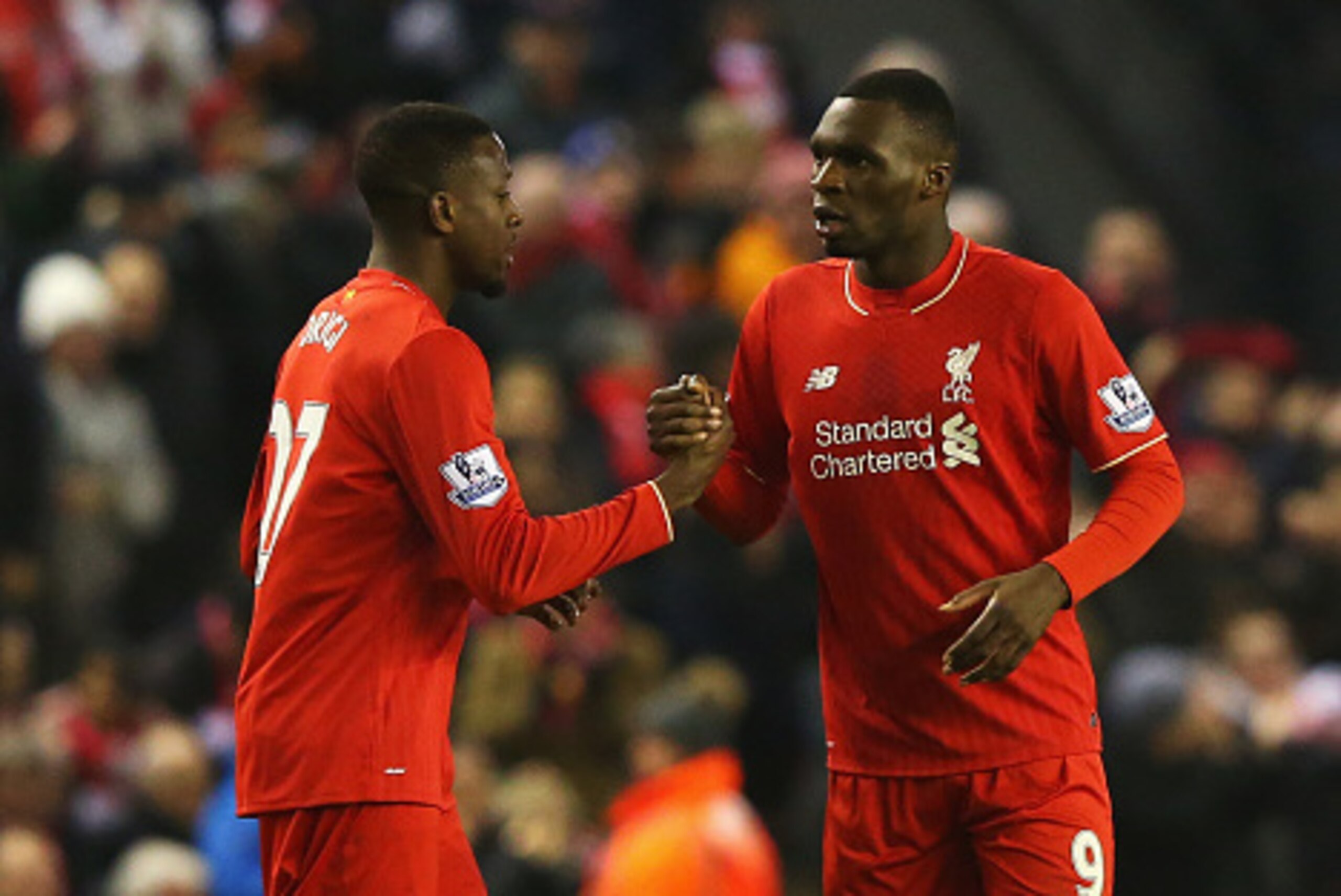LIVERPOOL, ENGLAND - DECEMBER 13:  Divock Origi of Liverpool (L) celebrates with Christian Benteke as he scores their second goal during the Barclays Premier League match between Liverpool and West Bromwich Albion at Anfield on December 13, 2015 in Liverp
