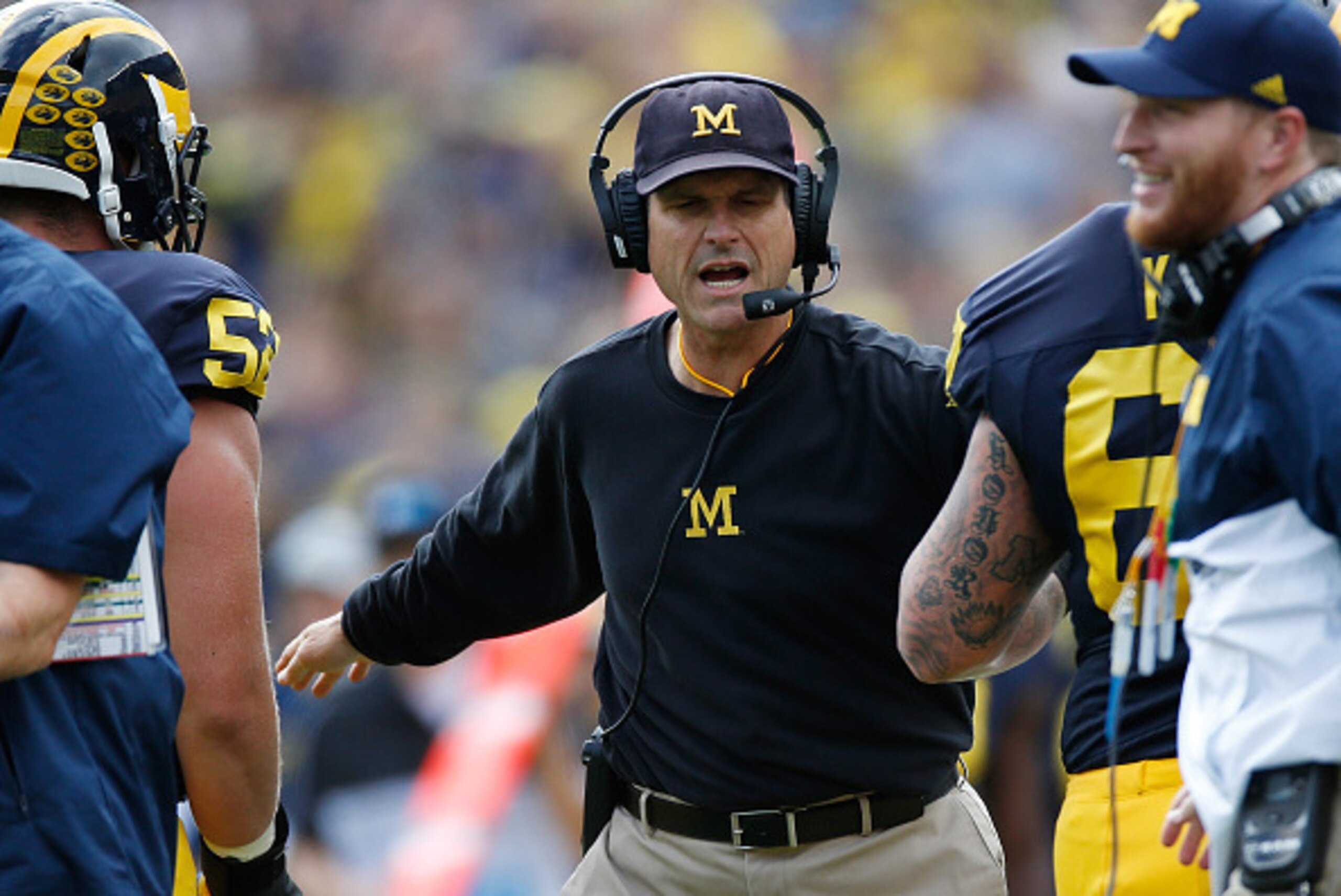 ANN ARBOR, MI - SEPTEMBER 19:  Head coach Jim Harbaugh celebrates a second quarter touchdown with his players while playing the UNLV Rebels on September 19, 2015 at Michigan Stadium in Ann Arbor, Michigan.  (Photo by Gregory Shamus/Getty Images)