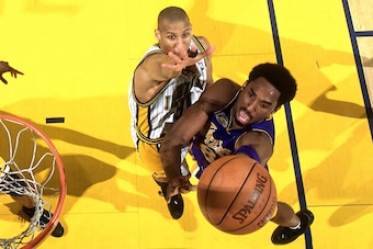 INDIANAPOLIS - JUNE 14:  Kobe Bryant #8 of the Los Angeles Lakers attempts a layup against Reggie Miller #31 of the Indiana Pacers during Game Four of the 2000 NBA Finals played June 14, 2000 at Conseco Field House in Indianapolis, Indiana.  NOTE TO USER: