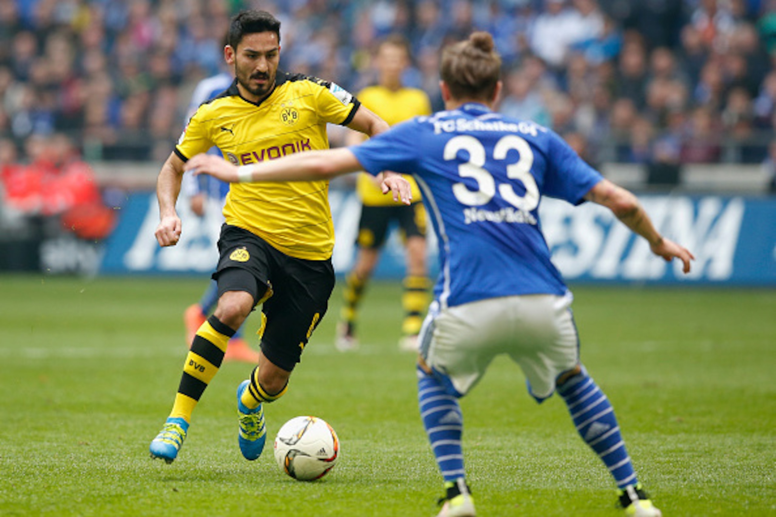 GELSENKIRCHEN, NORTH RHINE-WESTPHALIA - APRIL 10:  Roman Neustaedter (R) of FC Schalke 04 challenges Ilkay Guendogan of Borussia Dortmund during the Bundesliga match between FC Schalke 04 and Borussia Dortmund at Veltins-Arena on April 10, 2016 in Gelsenk
