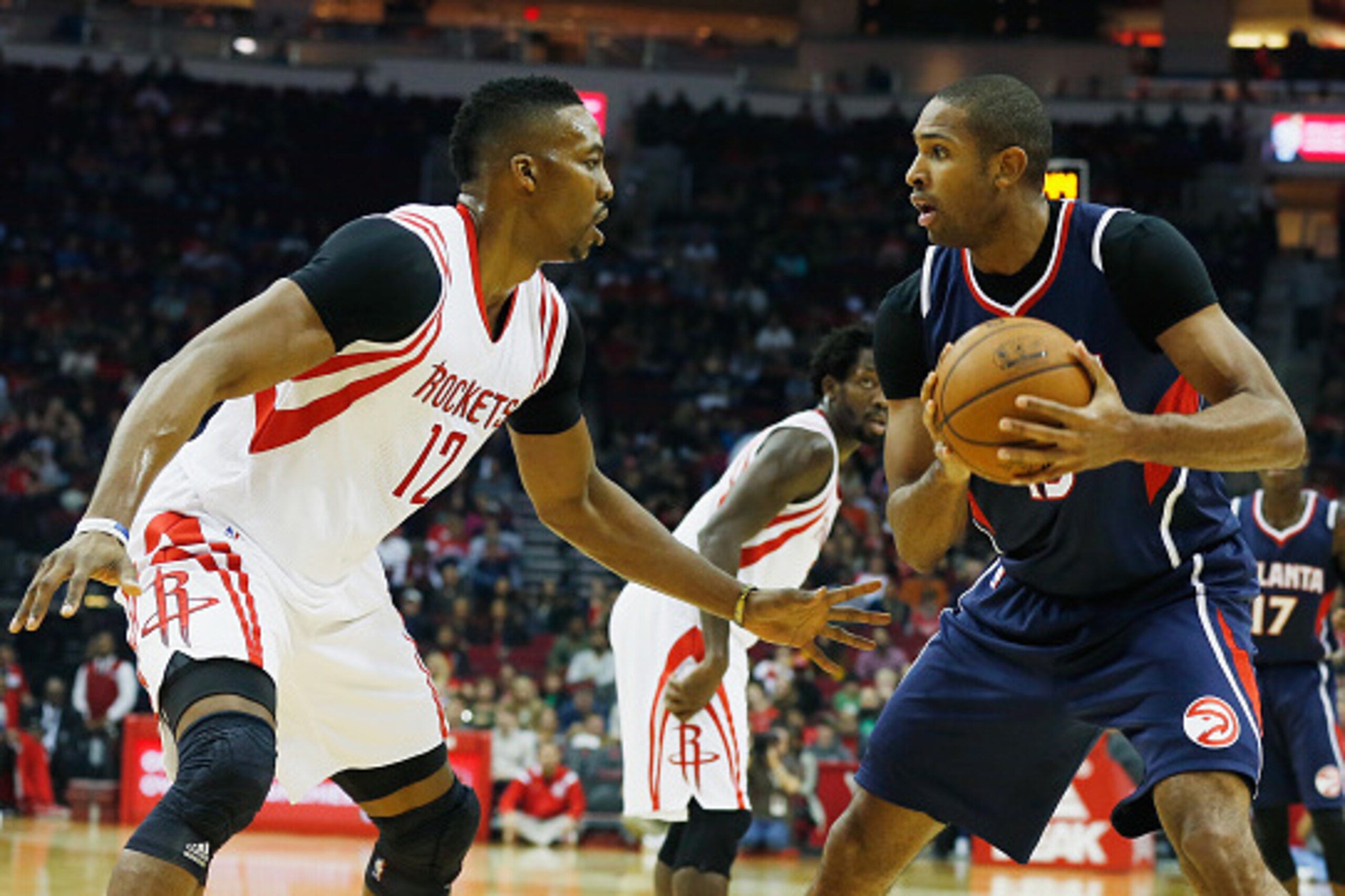 HOUSTON, TX - DECEMBER 20:  Dwight Howard #12 of the Houston Rockets defends against Al Horford #15 of the Atlanta Hawks during their game at the Toyota Center on December 20, 2014 in Houston, Texas.  (Photo by Scott Halleran/Getty Images)