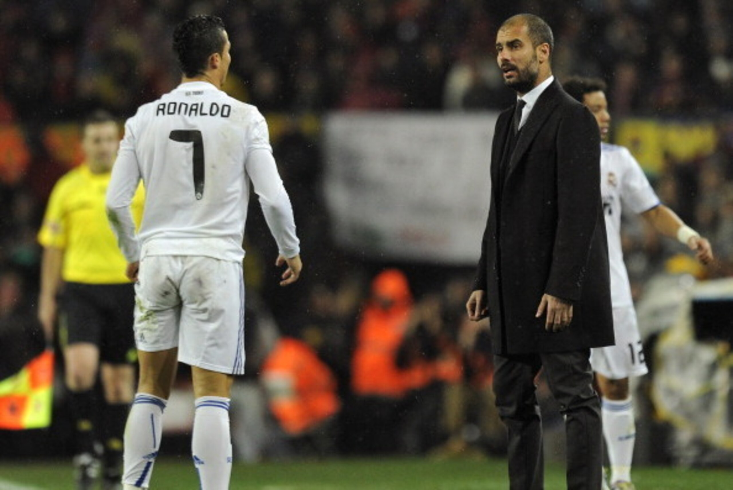 Real Madrid's Portuguese forward Cristiano Ronaldo (L) watches Barcelona's coach Josep Guardiola during the Spanish league 'clasico' football match FC Barcelona vs Real Madrid at Camp Nou stadium on November 29, 2010 in Barcelona. Barcelona won 5-0.     A