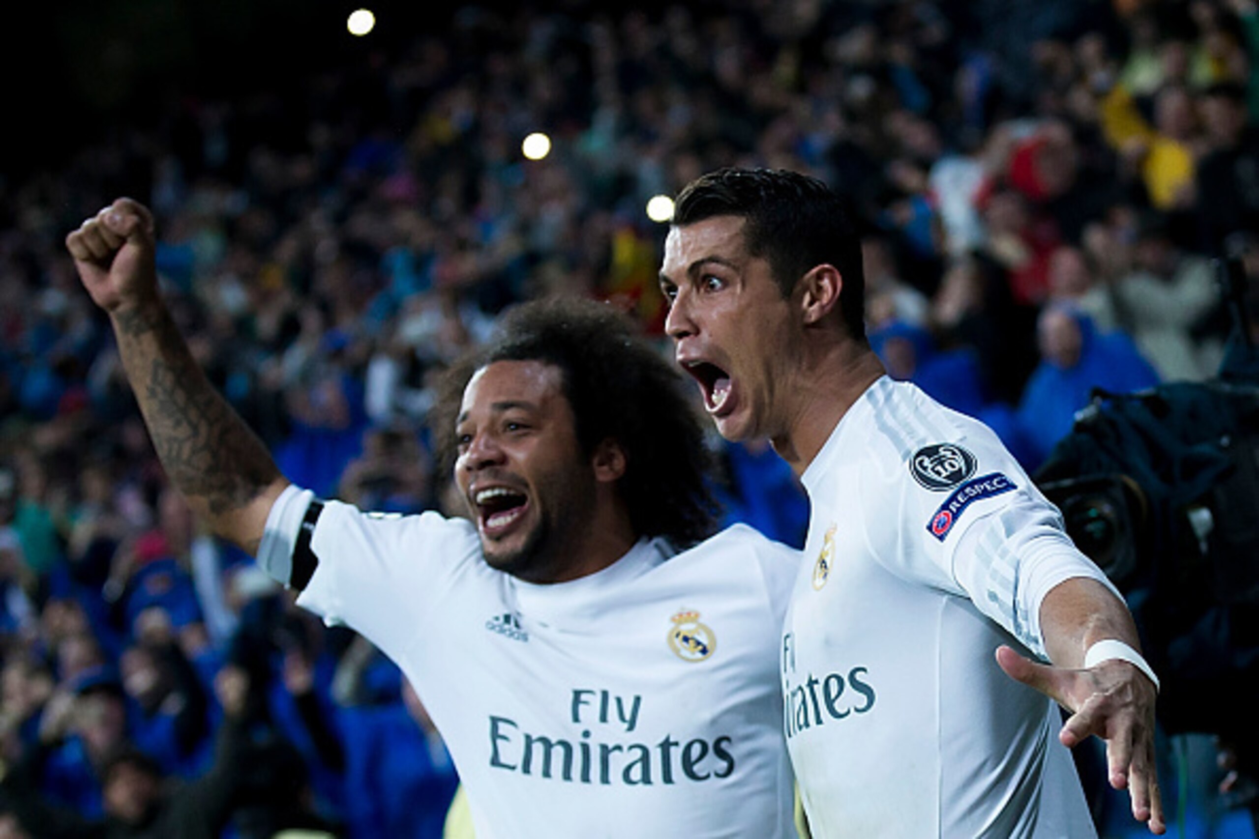 MADRID, SPAIN - APRIL 12:  Cristiano Ronaldo (R) of Real Madrid CF celebrates scoring their third goal with teammate Marcelo (L) during the UEFA Champions League quarter final second leg match between Real Madrid CF and VfL Wolfsburg at Estadio Santiago B