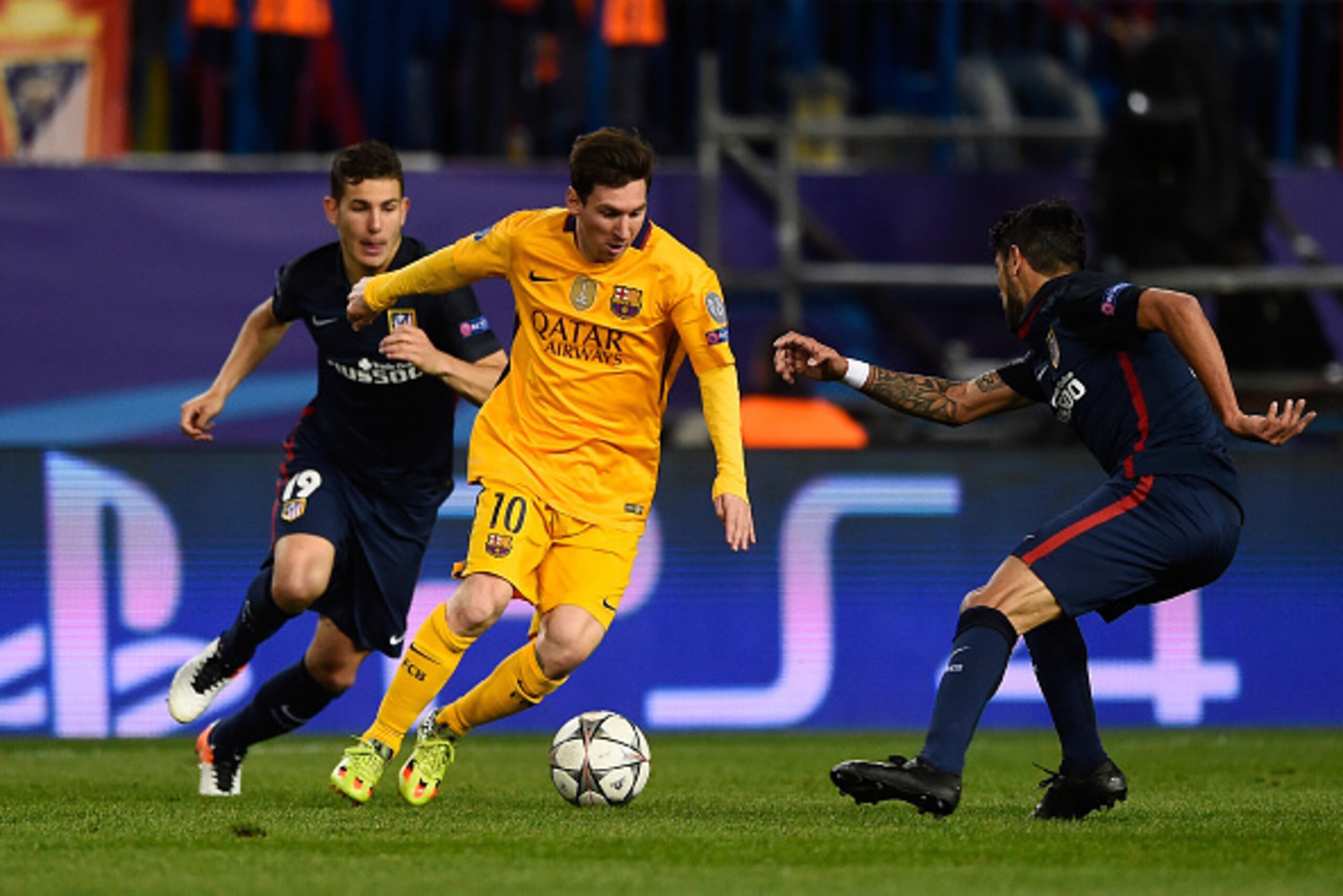 MADRID, SPAIN - APRIL 13:  Lionel Messi of Barcelona takes the ball past Lucas Hernandez of Atletico Madrid during the UEFA Champions League quarter final, second leg match between Club Atletico de Madrid and FC Barcelona at the Vincente Calderon on April