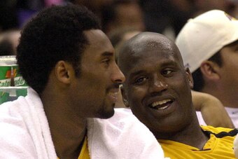 LOS ANGELES, UNITED STATES:  Kobe Bryant of the Los Angeles Lakers (L) and teammate Shaquille O'Neal sit on the bench during game 5 of the NBA Western Conference Semifinal Series 16 May 2000 against the Phoenix Suns in Los Angeles. The Lakers went on to w