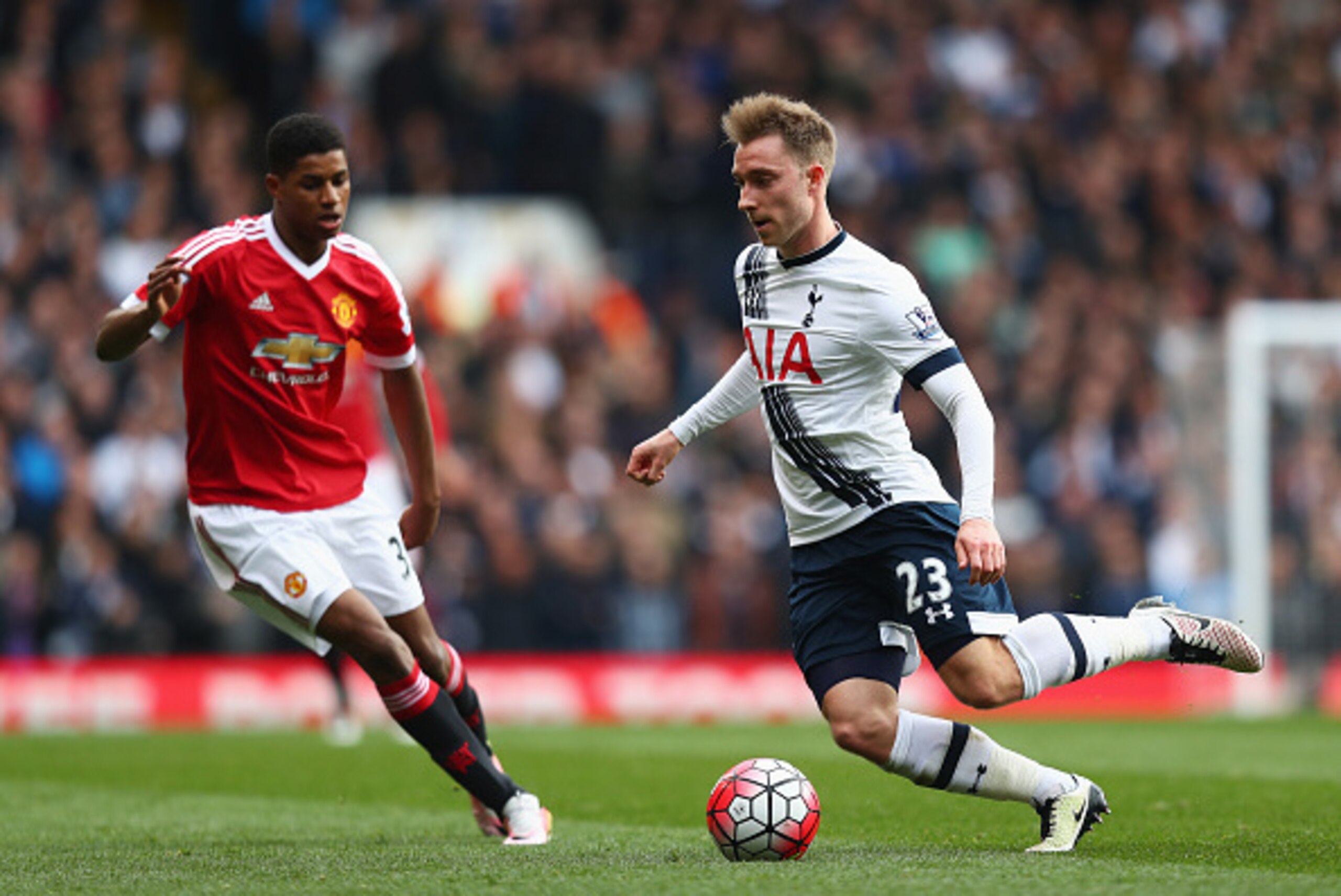 LONDON, ENGLAND - APRIL 10:  Christian Eriksen of Tottenham Hotspur is watched by Marcus Rashford of Manchester United during the Barclays Premier League match between Tottenham Hotspur and Manchester United at White Hart Lane on April 10, 2016 in London,