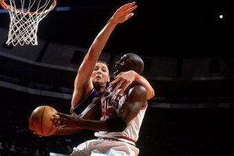 CHICAGO - JUNE 7:  Michael Jordan #23 of the Chicago Bulls attempts a layup against Greg Ostertag #00 of the Utah Jazz in Game Three of the 1998 NBA Finals at the United Center on June 5, 1998 in Chicago, Illinois.  The Bulls won 96-54.  NOTE TO USER: Use