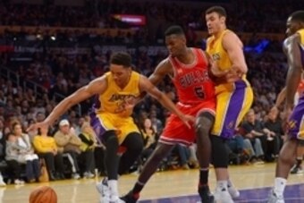 Jan 28, 2016; Los Angeles, CA, USA; Chicago Bulls forward Bobby Portis (5), Los Angeles Lakers forward Larry Nance Jr. (7) and forward Anthony Brown (3) battle for a loose ball in the second half at Staples Center. The Bulls won 114-91. Mandatory Credit: 