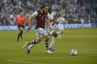 Apr 13, 2016; Kansas City, KS, USA; Colorado Rapids midfielder Shkelzen Gashi (11) and Sporting Kansas City defender Ike Opara (3) fight for the ball during the first half of the match at Children's Mercy Park. Colorado won 2-1. Mandatory Credit: Denny Me